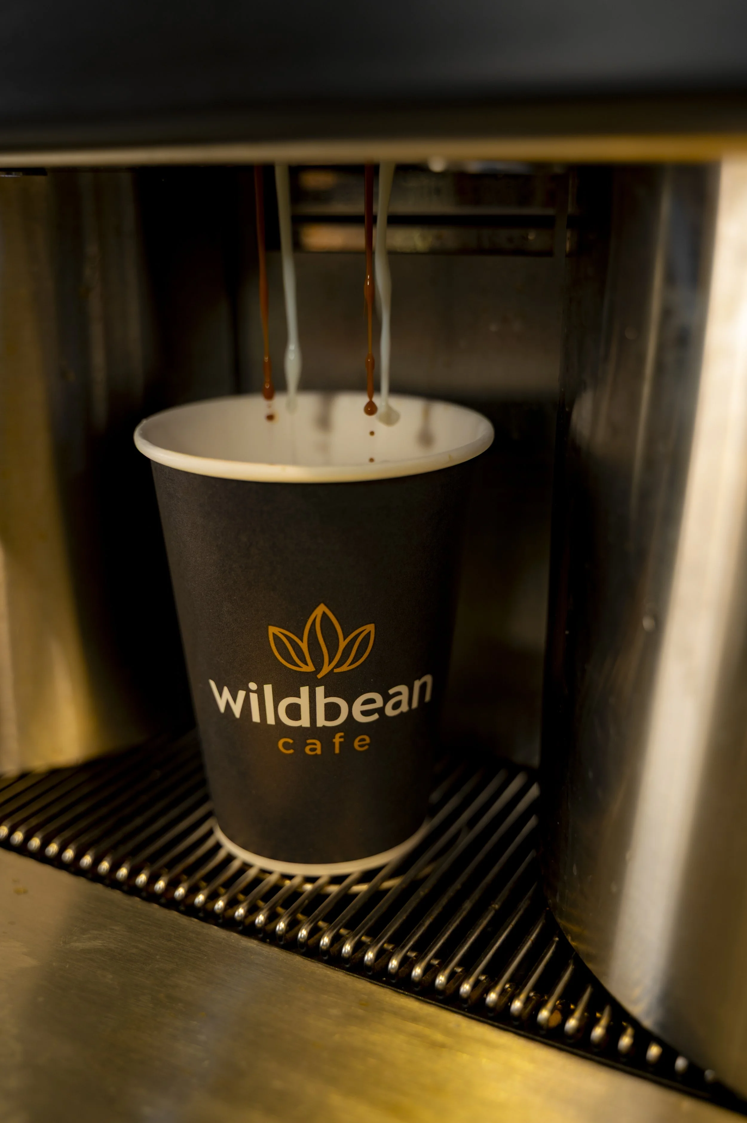 BP Wildbean cafe new branding coffee cup being filled.