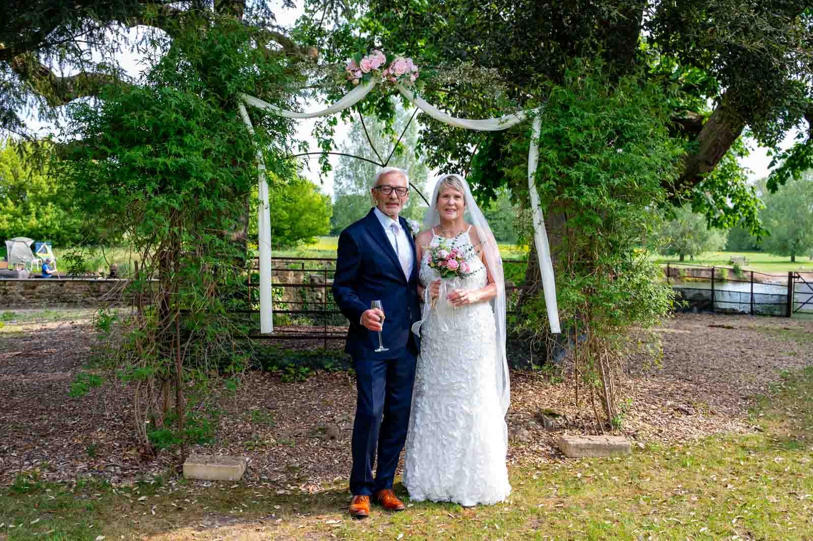 Bride and Groom pose for a photograph outside at Oxfordshire Wedding Venue, The Coseners House