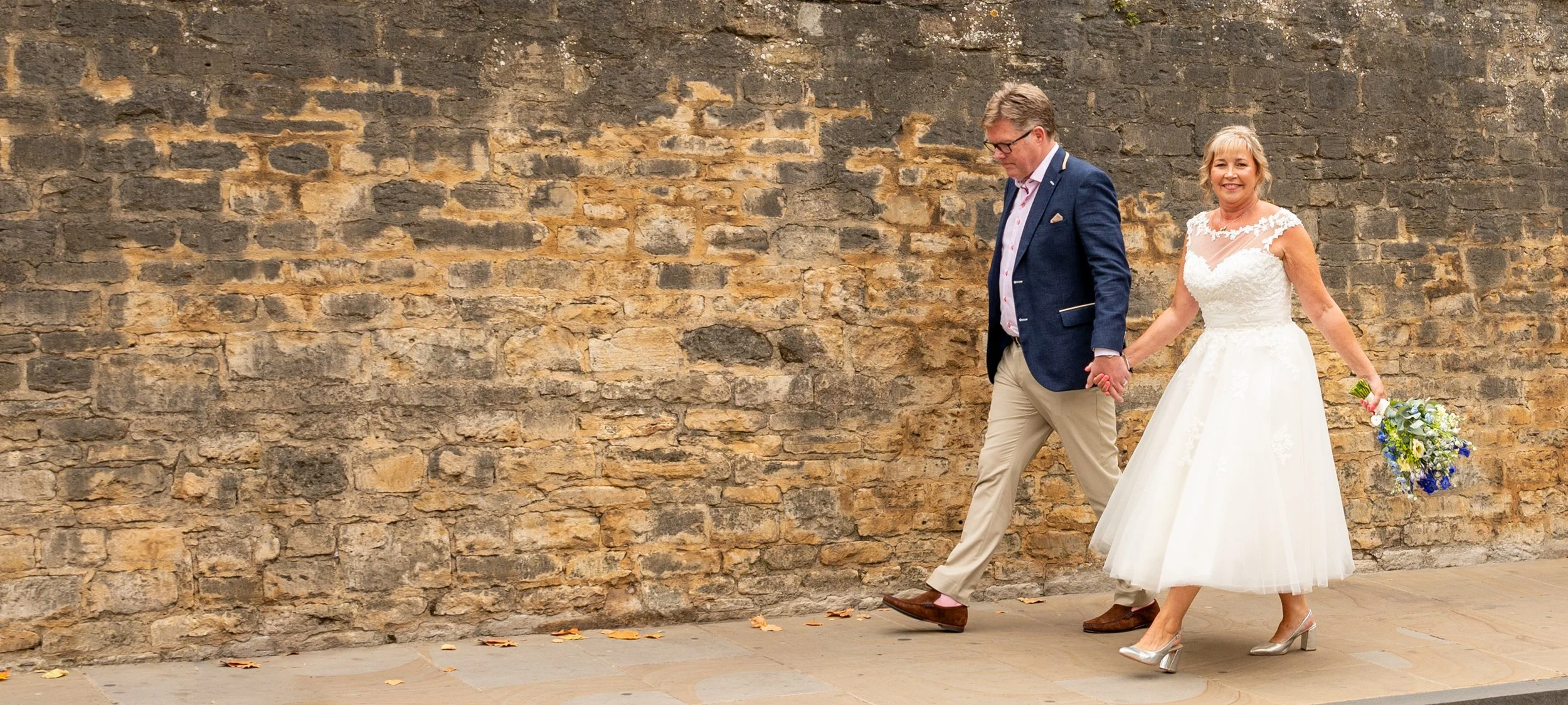 Bride and Groom walk in the streets of Oxford