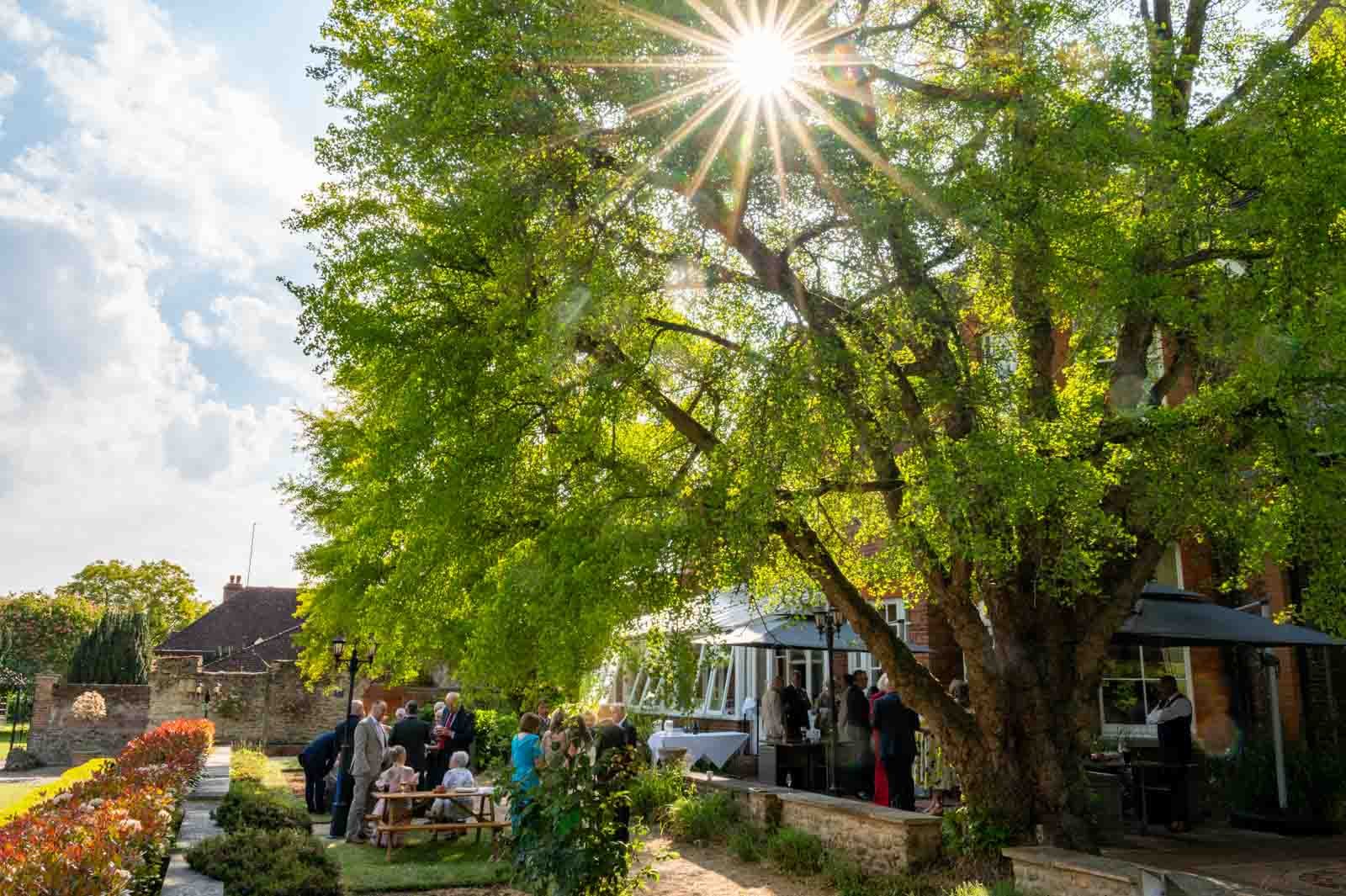 Wedding guests stood outside during a summer wedding at The Coseners House Abingdon