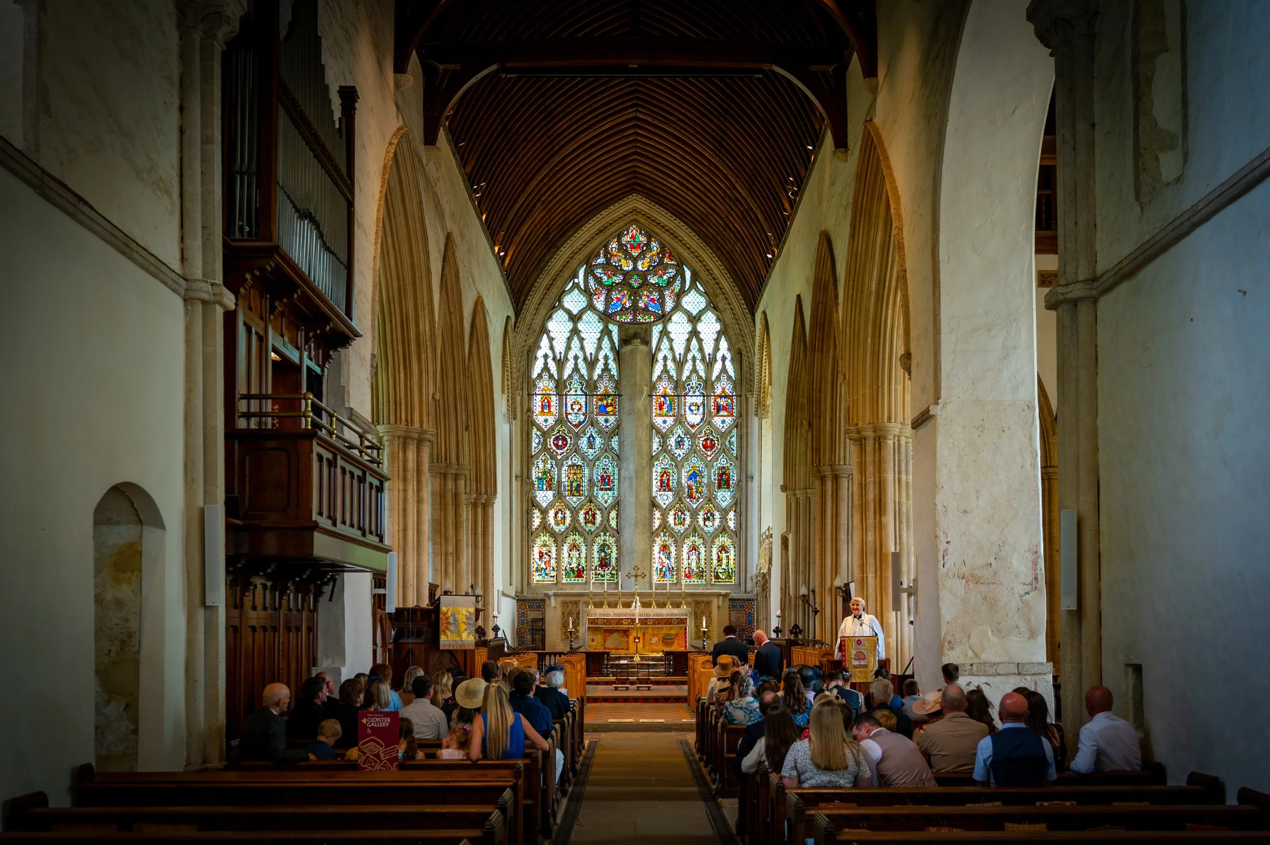 Guests attend a wedding at Dorchester Abbey in Oxfordshire