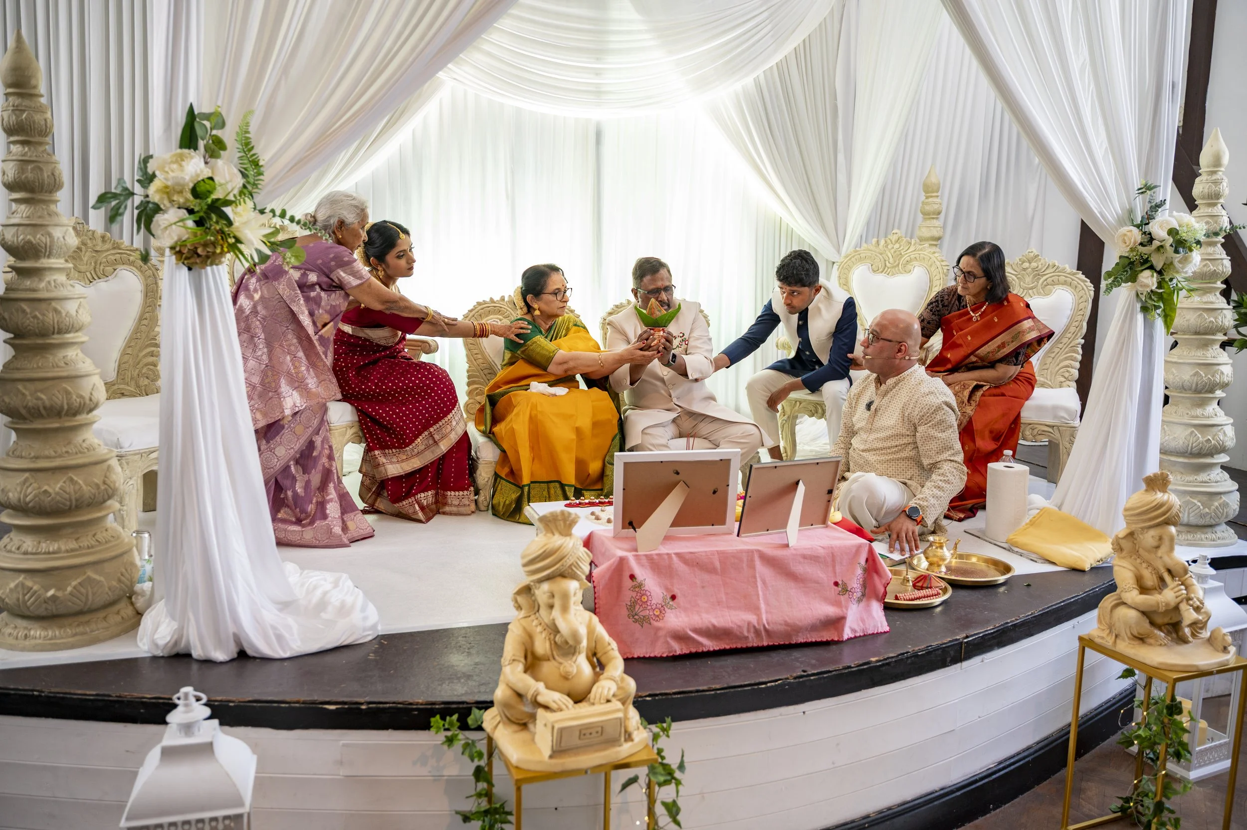The wedding party in the middle of the ceremony on a stage.