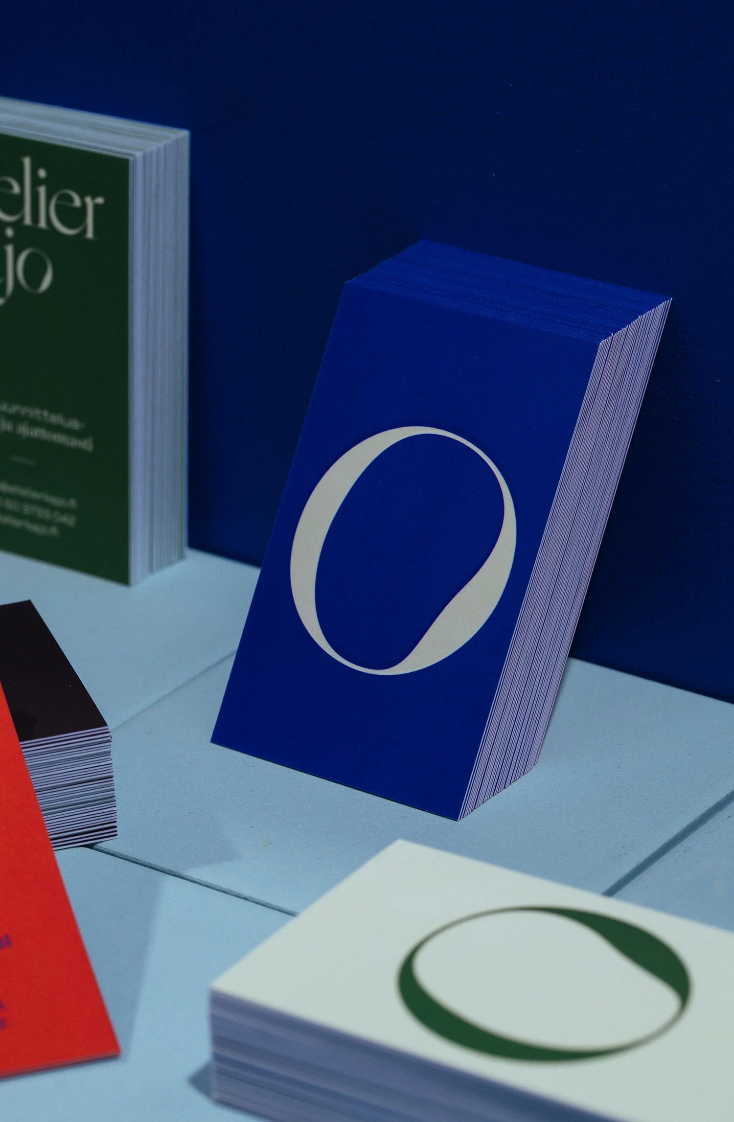 Close-up of colorful cards and paper with circular and text designs, arranged on a flat surface.