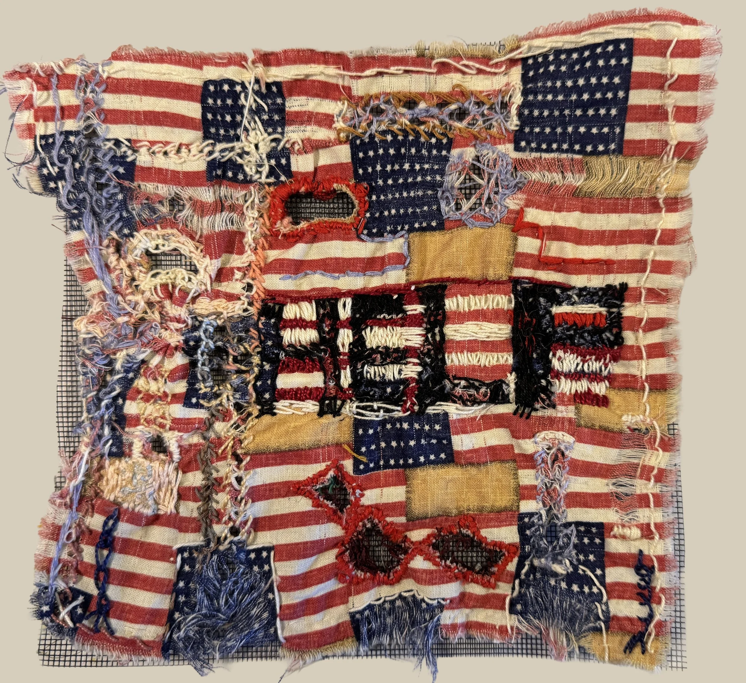  American Wounds. 9×9 inches. Reclaimed fabric printed with faux American flags, cutwork and pulled thread work, mounted on fiberglass screen. 