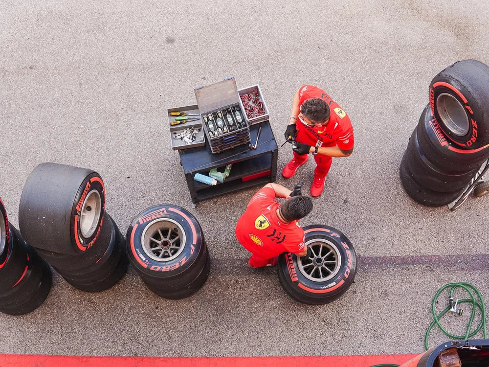 Ferrari F1 Team Members Checking Their Pirelli Tires
