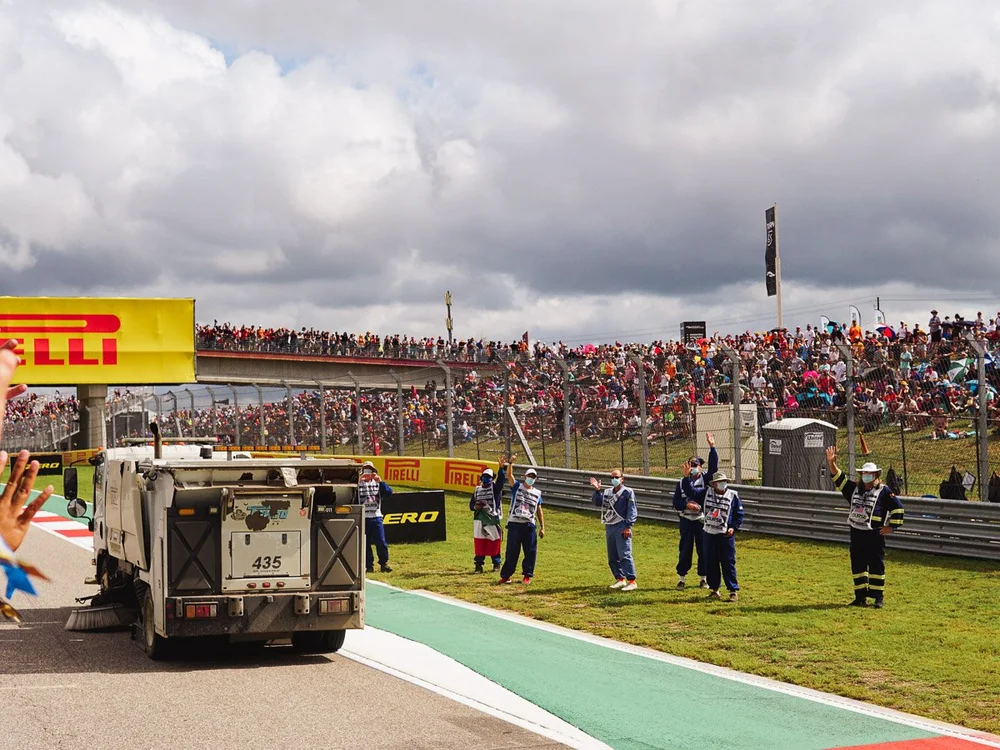 Fans and Track Marshals Waving