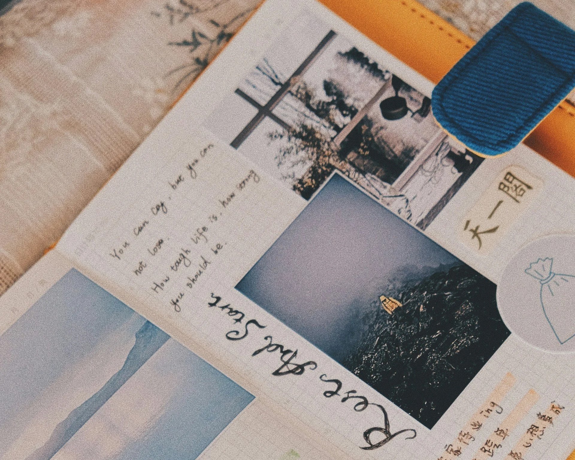 Close-up of a journal featuring English and Chinese writing alongside a collage of landscape photographs showing a window, trees, and water, representing identity, reflection, and connection to nature.