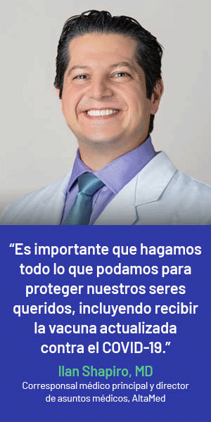 Smiling man in a lab coat with text in Spanish about COVID-19 vaccination by Ilan Shapiro, MD, from AltaMed.