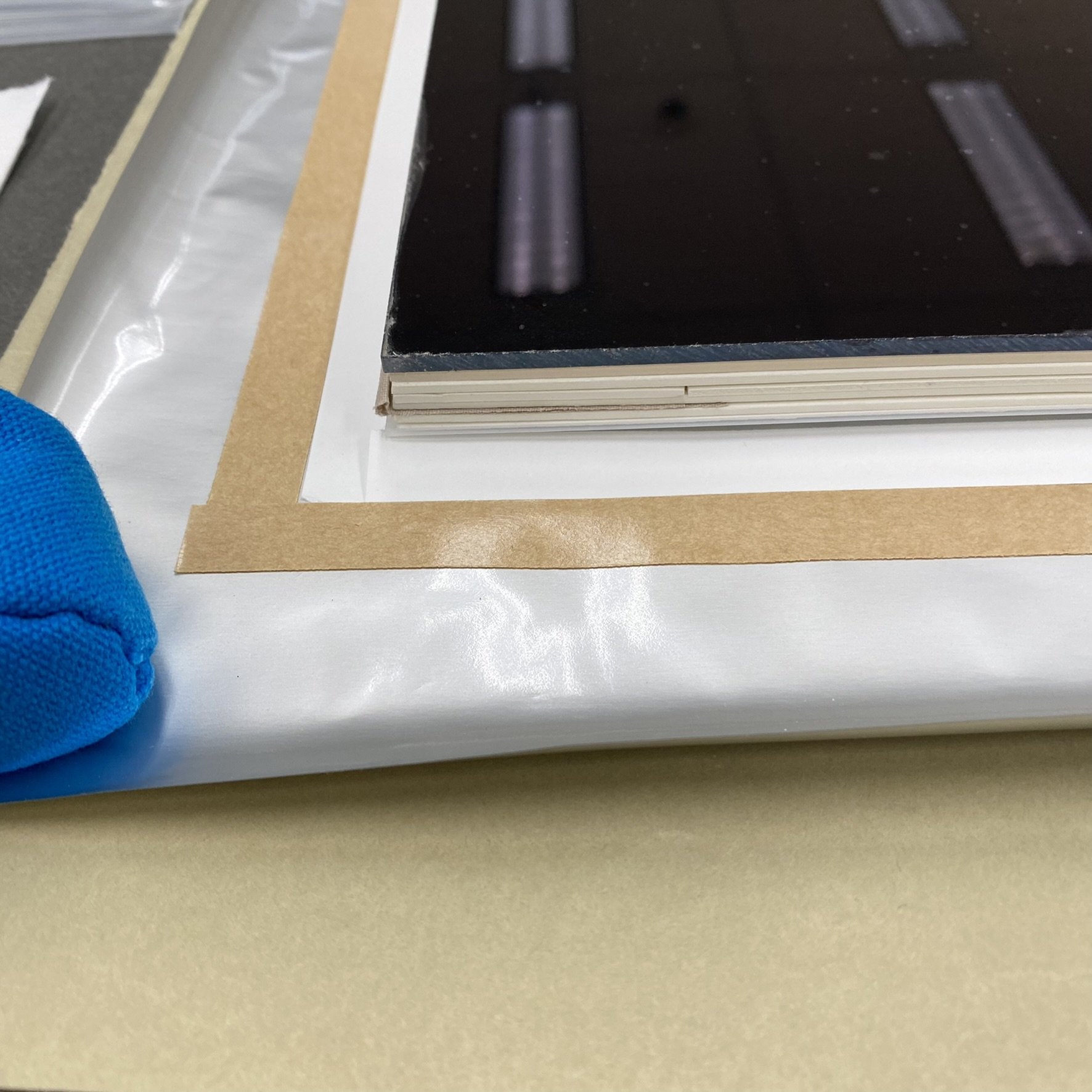 1. Paper placement to block double-sided tape from adhering to original housing mat