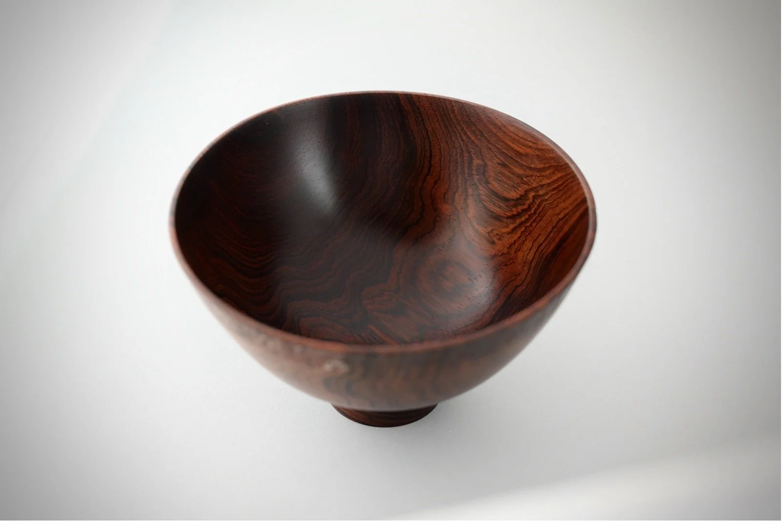 Hand-turned exotic hardwood bowl by Bob Stocksdale with dramatic grain and sculptural organic form