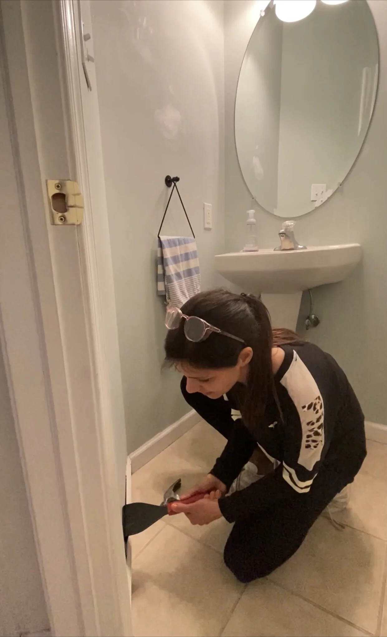 Removing baseboards first.The first step to removing all of the tile was removing the baseboards. I BEGAN by scoring the top of the trim with a utility knife. Then I used this trim puller to get behind the molding and easily remove it without damaging the drywall behind it! This tool is a must to have!