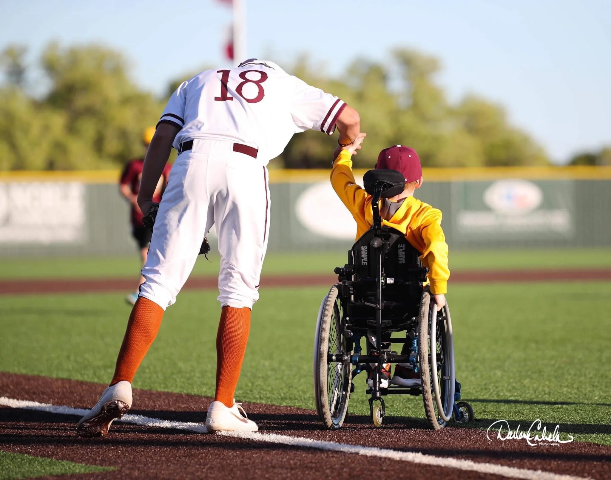 [WRITE TO IMAGE — the WillPower baseball tournament; describe the scene]
