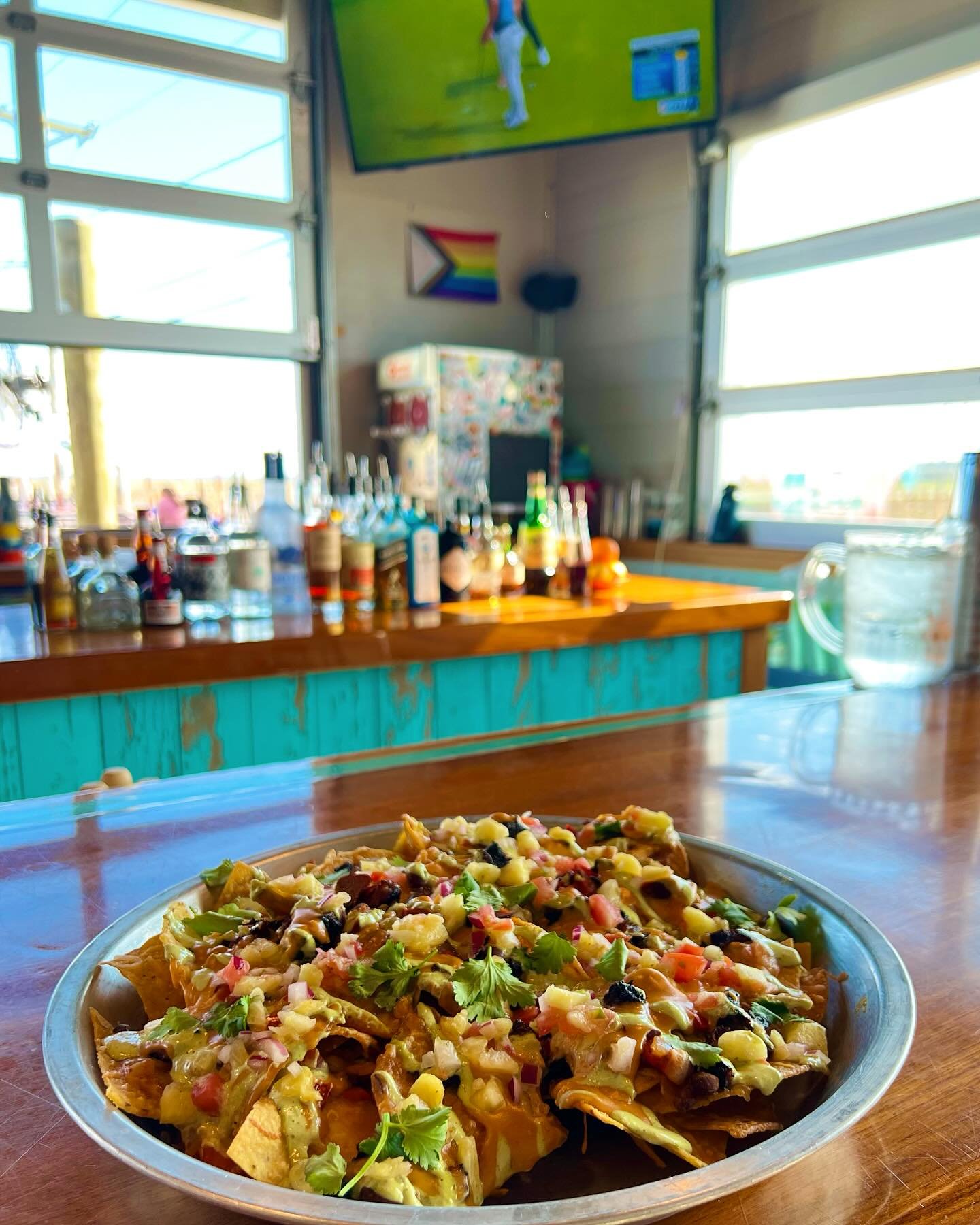 Celtics start at 7pm, nachos go all night!  House fried corn tortillas topped with smoked chicken, chile queso, pineapple pico, black beans, garlic herb crema! #sunsetclub #plumisland #nachos #celtics #islandlife #beachbar #northshorema