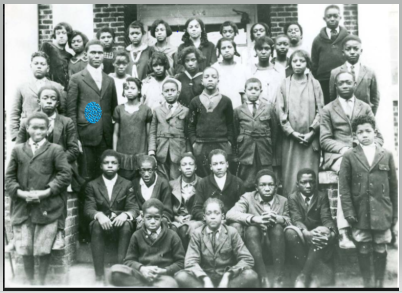   With 100% certainty, the principal and eventual dean at Winston-Salem State University, Dr. Bianchi is the gentleman standing with the students (turquoise on the jacket) on the left. These students changed the school name in 1927 to Dunbar High Sch
