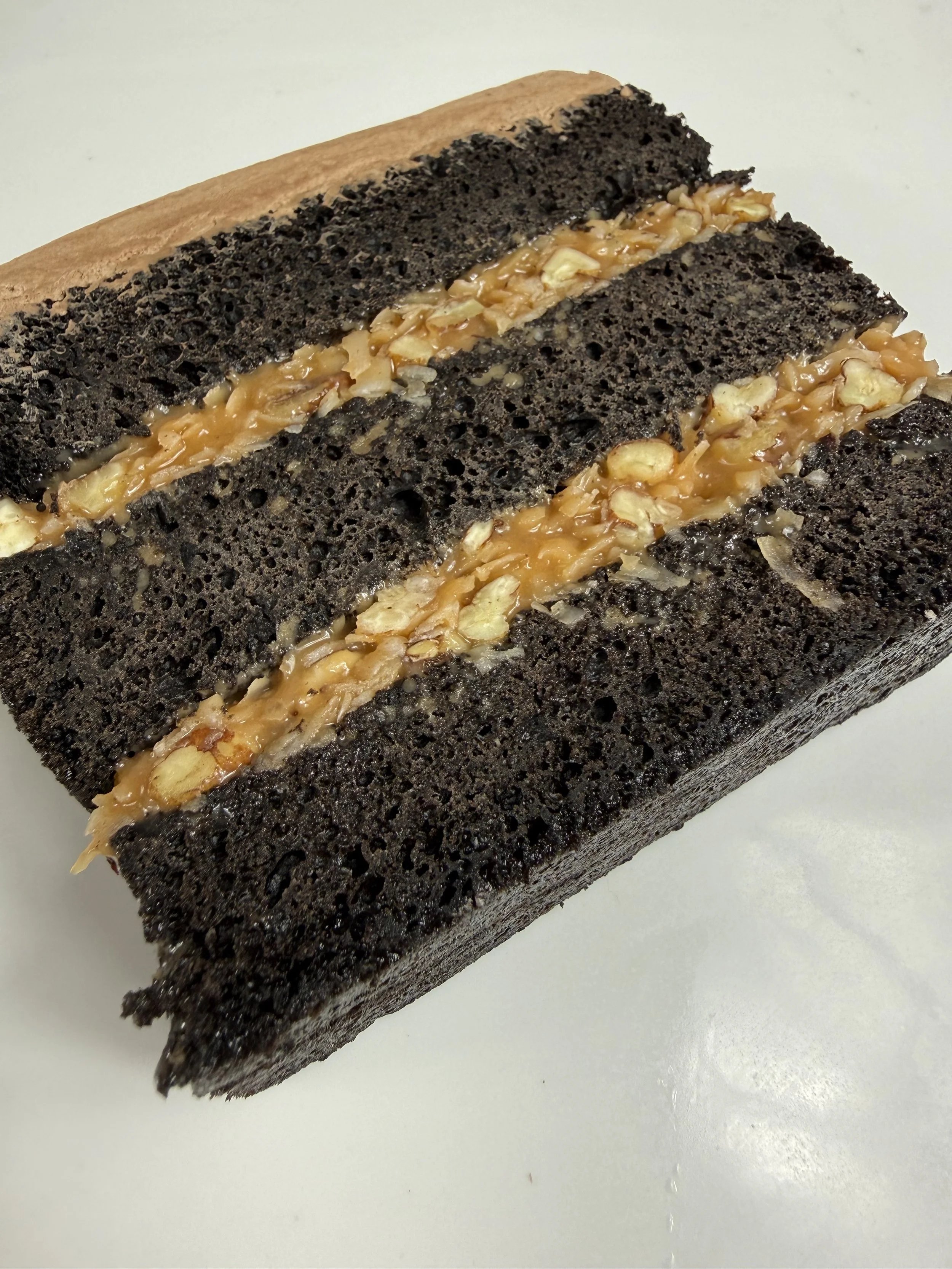  German Chocolate: 
Our rich chocolate cake layered with our delicious coconut & pecan German filling. Only available in the German Chocolate design.