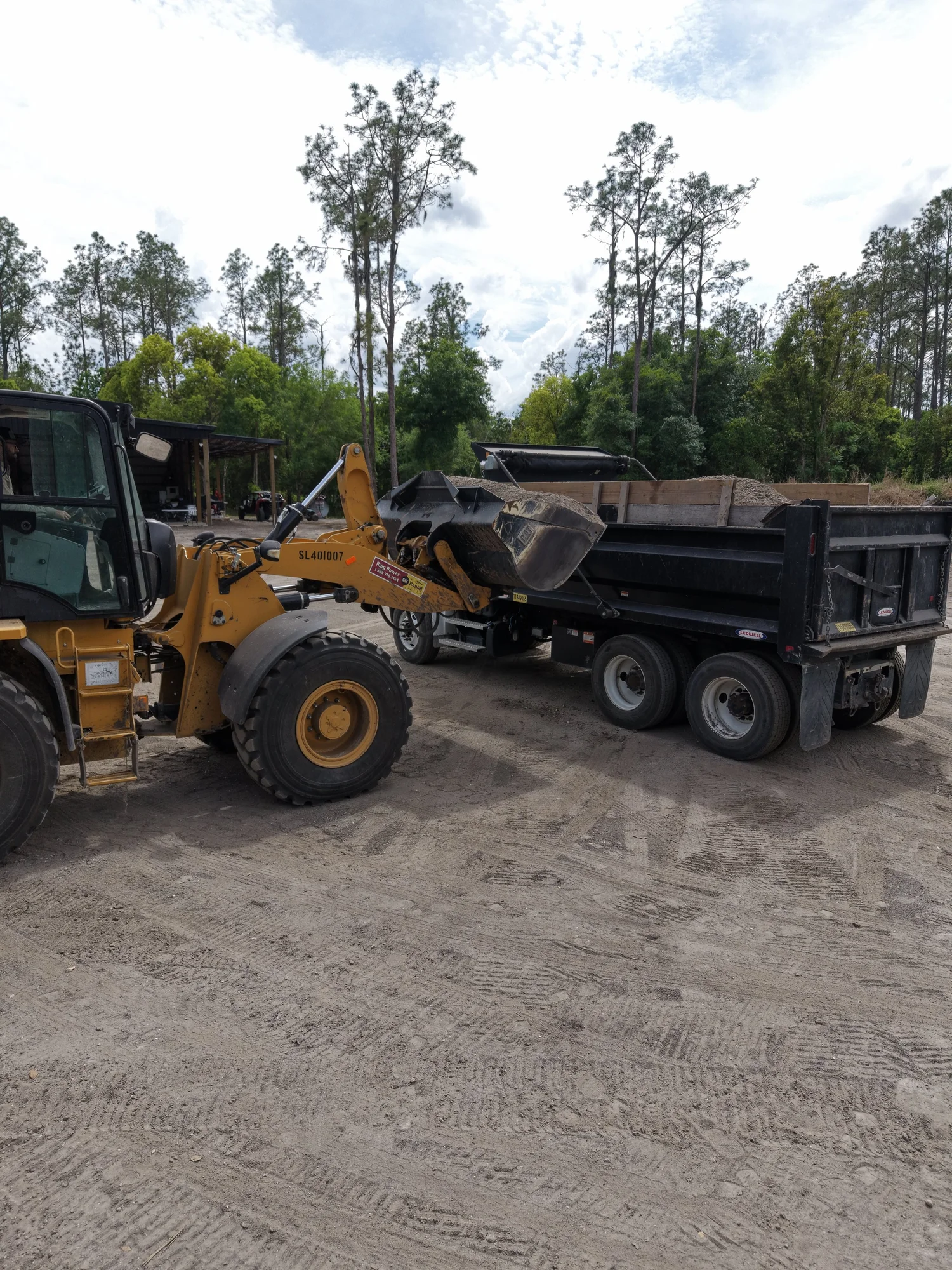 Loader placing material into a dump truck