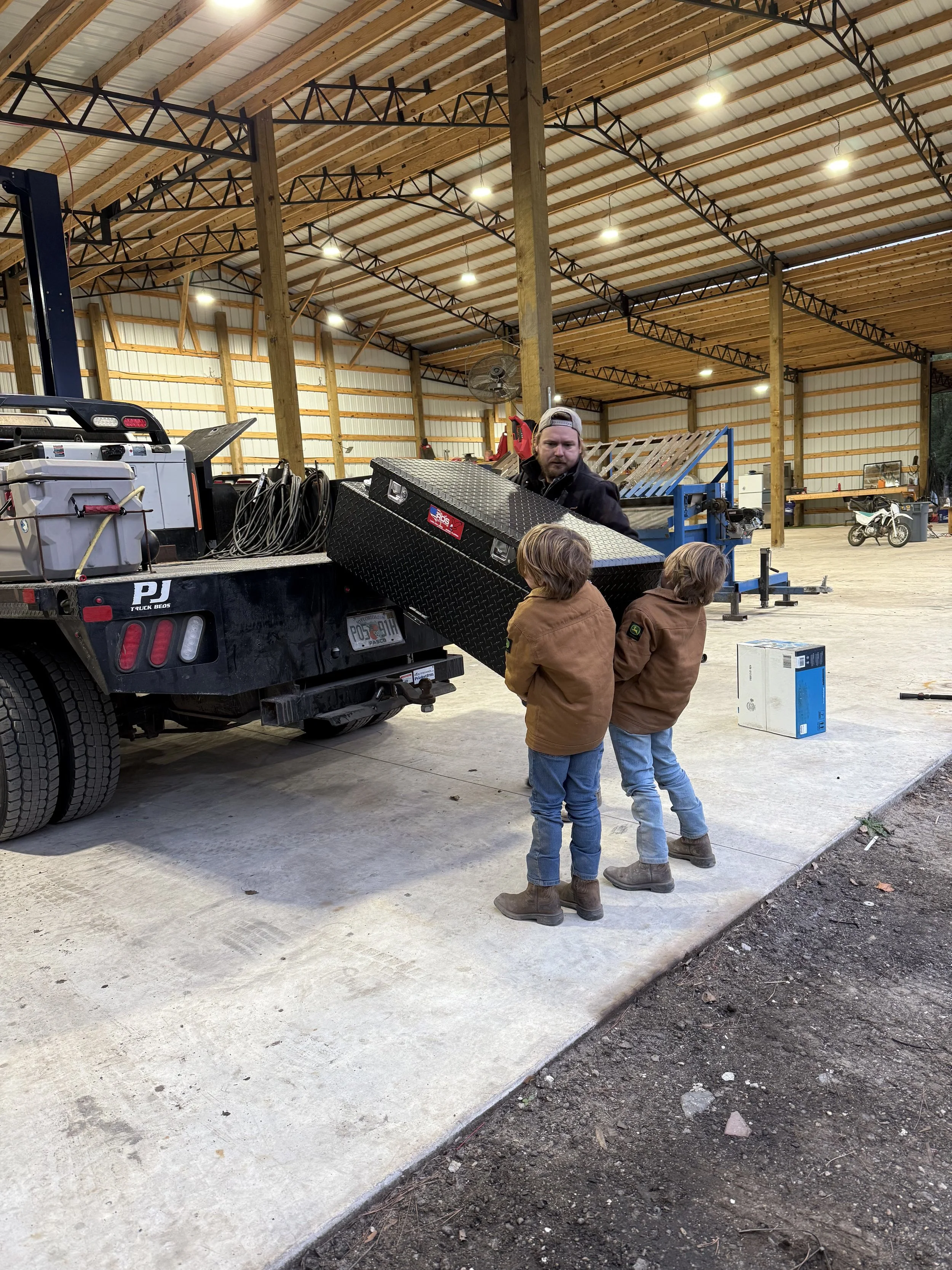 The boys helping the owner in the shop
