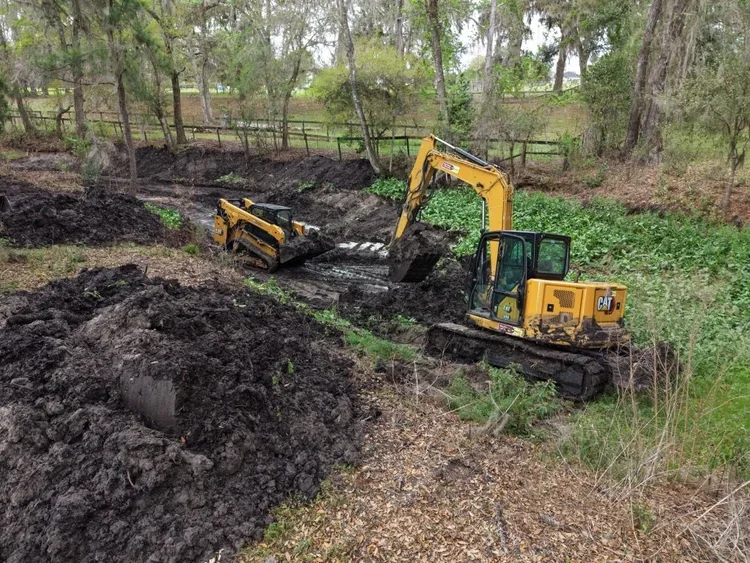 Excavator demucking for new drainage