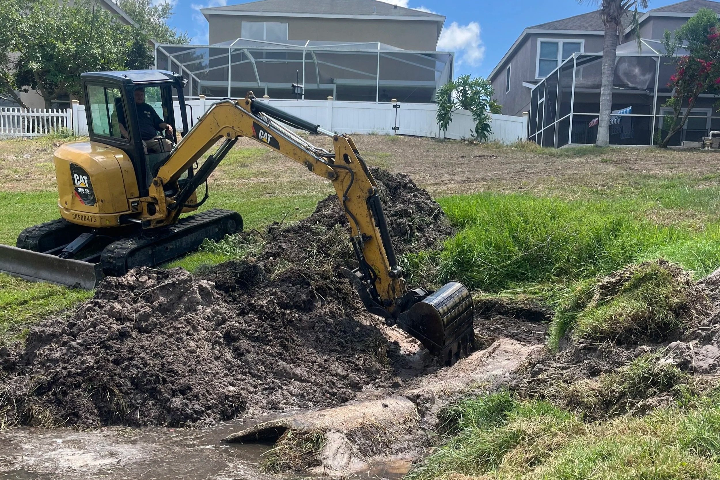 Excavator digging out a drainage solution