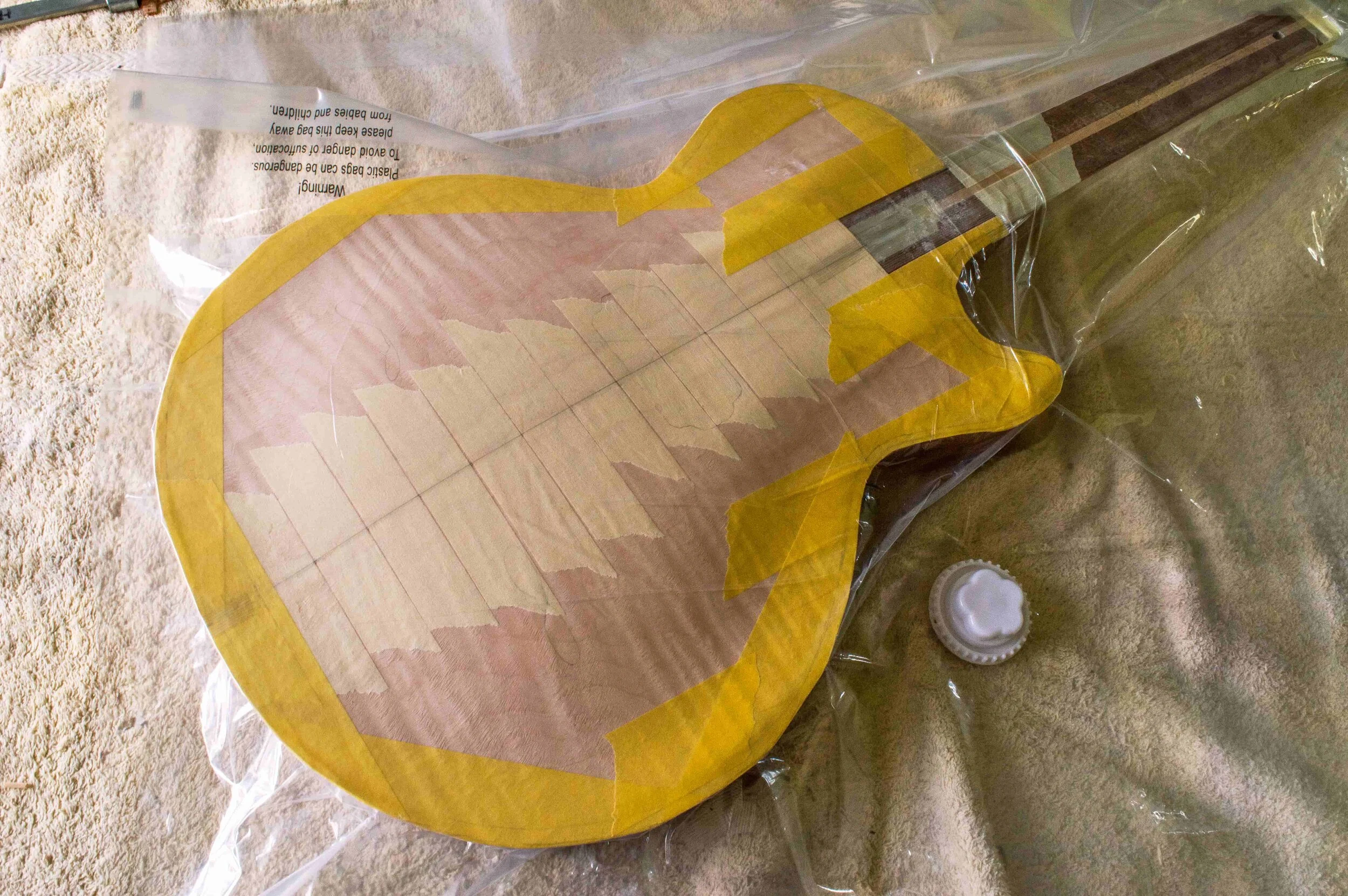 The yellow masking tape strengthens the edges and the pale masking tape is fixed across the centre join before the body goes into the vacuum press.