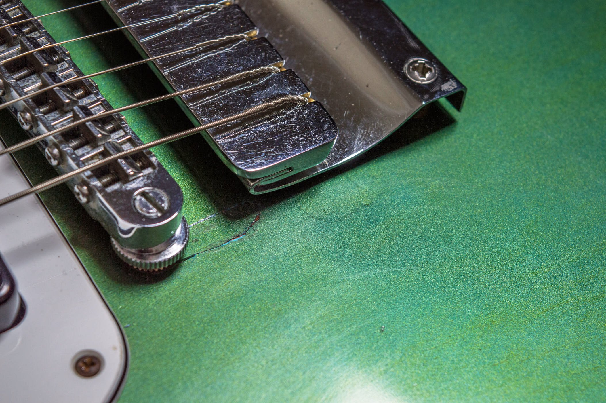 There’s some damage around the bass side bushing and a filled hole showing through the lacquer is evidence of a stop tailpiece.