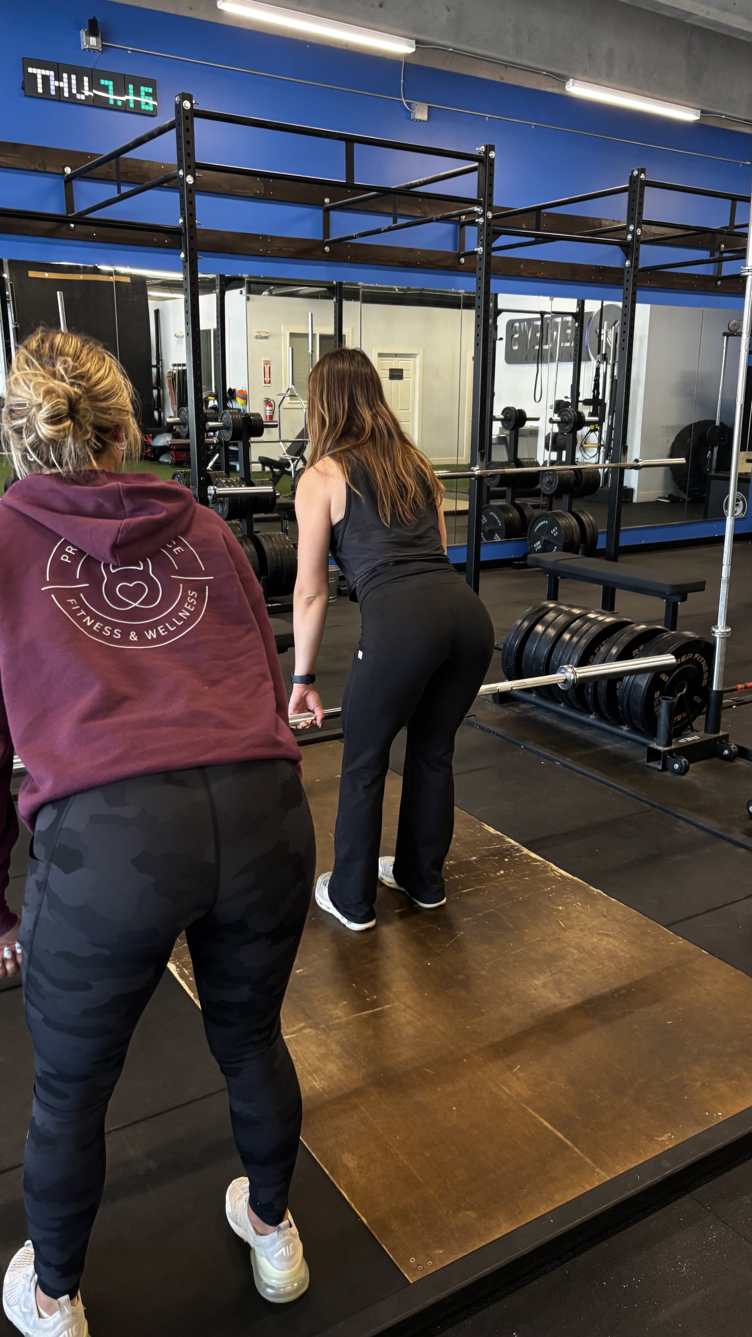 Personal trainer coaching a client through a strength training session as part of a physiology-first coaching method in Fort Collins, Colorado.