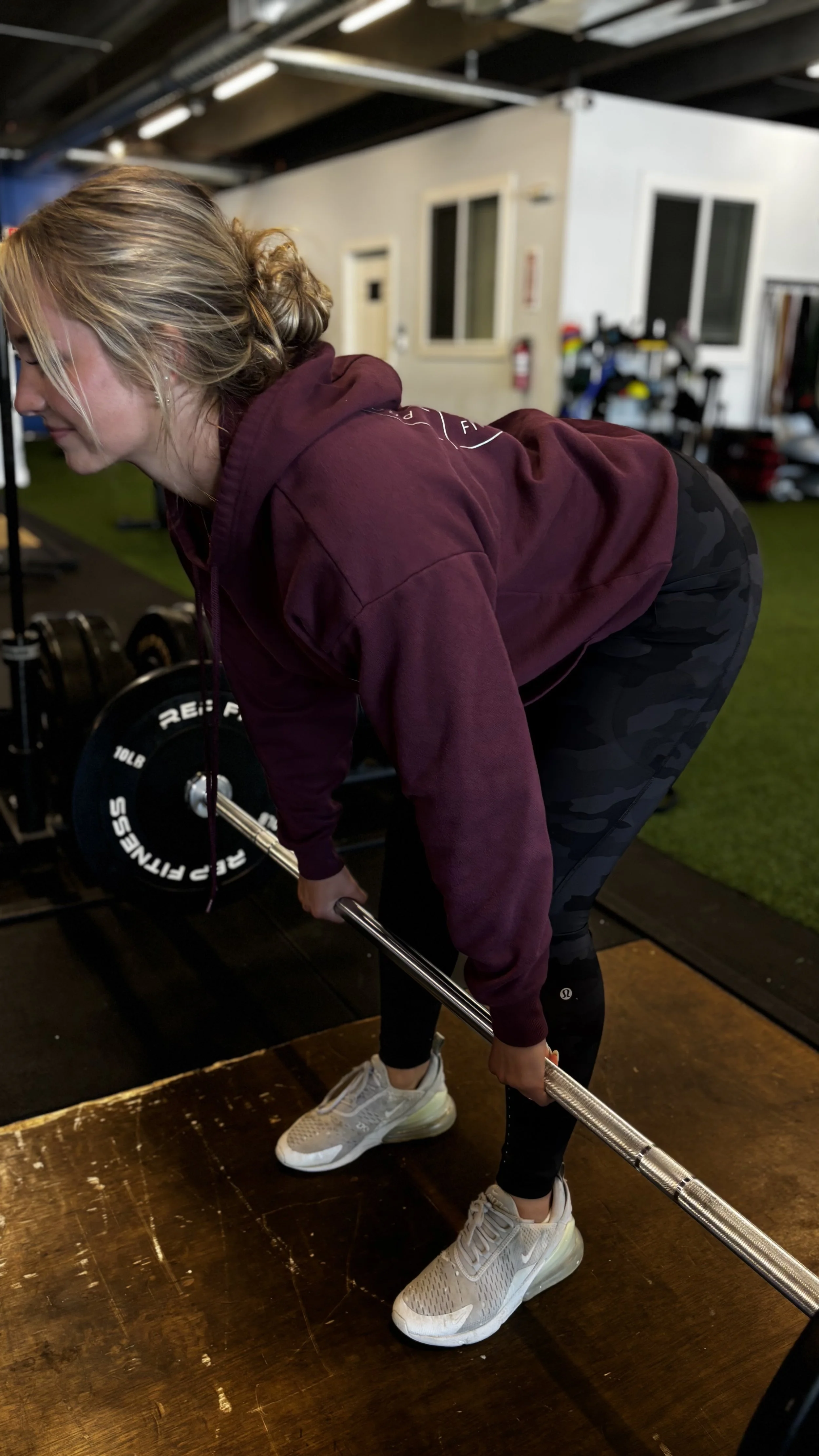 Woman following an online personal training workout at home with virtual coaching support.