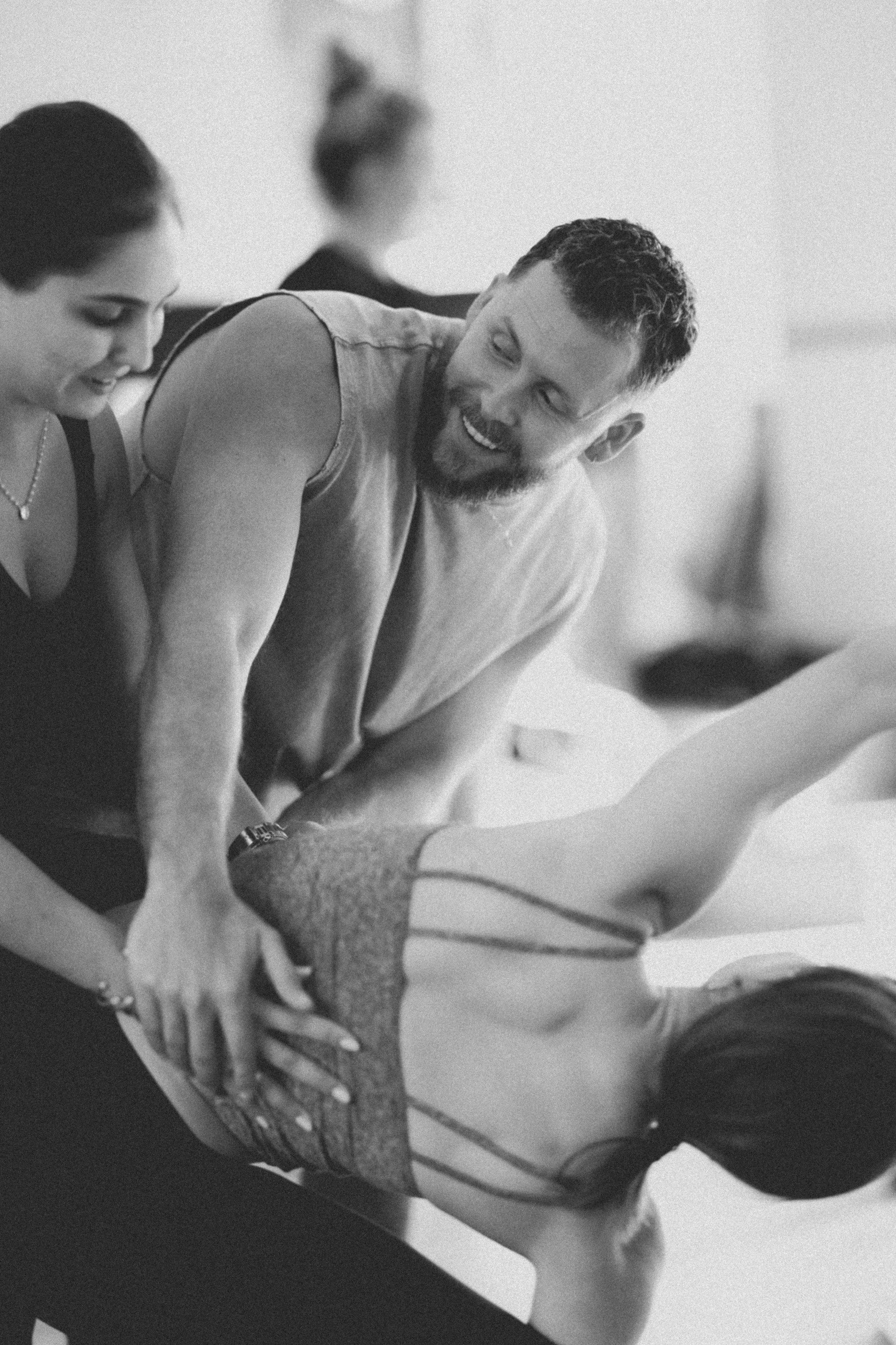 Tom offering hands-on guidance to a student during a movement session.