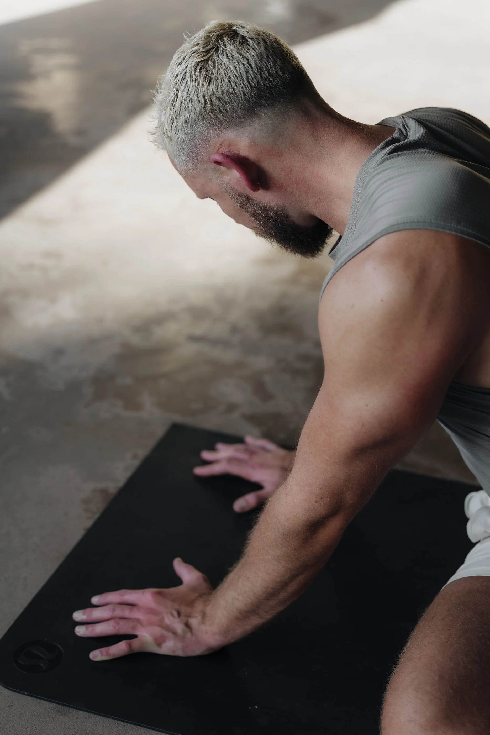 Tom demonstrating a hands-supported mobility exercise on a mat for EASE.
