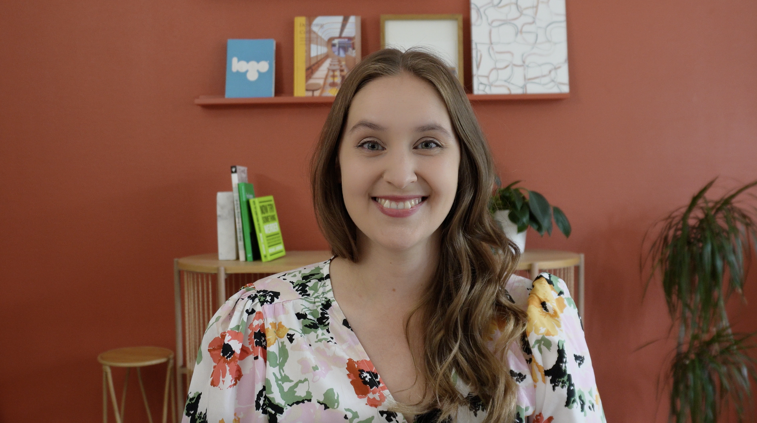 Malin smiling at the camera sitting in a design studio
