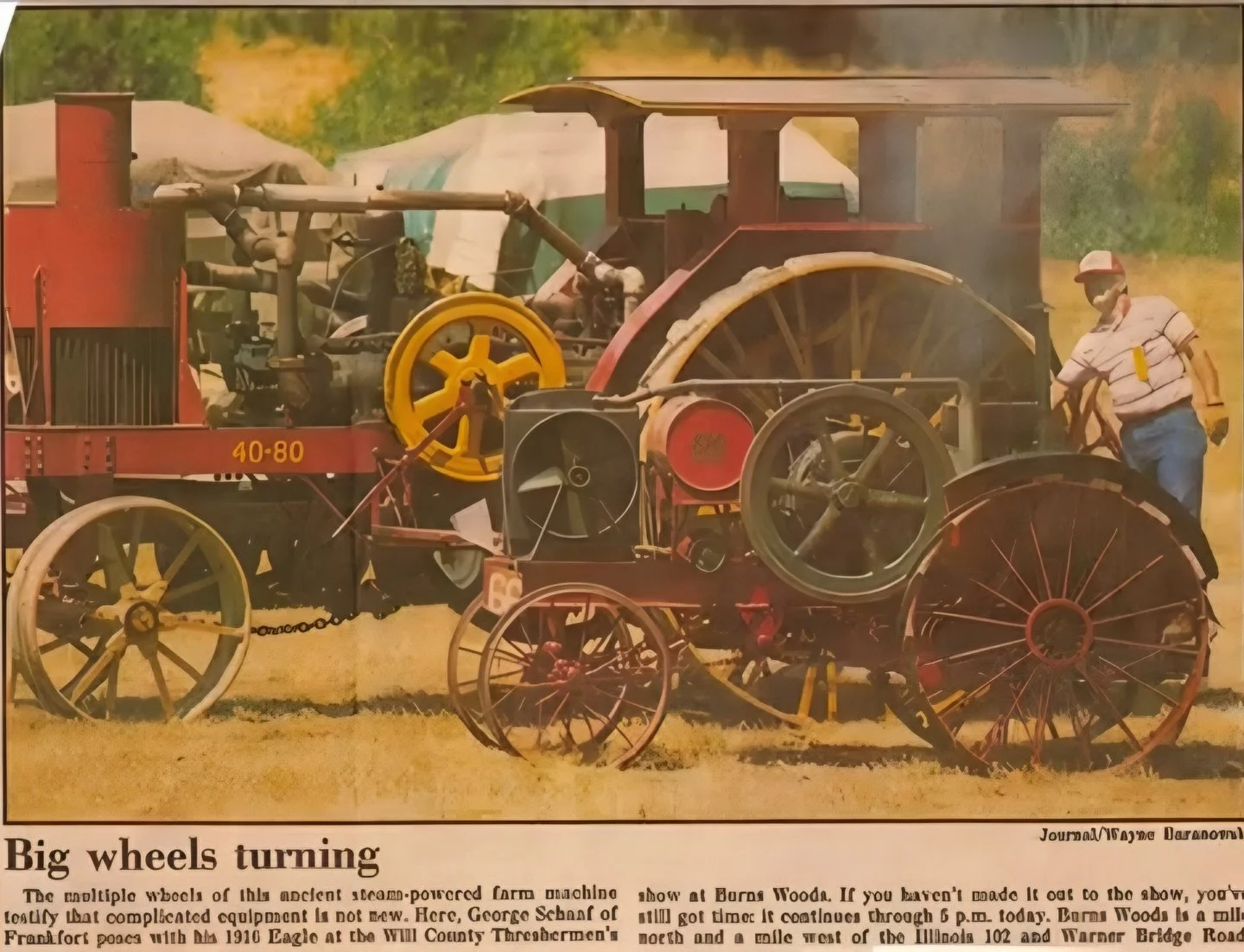 Flashback to a newspaper clipping of our Annual Show many years ago. &ldquo;Big wheels turning.&rdquo;
The multiple wheels of this ancient steam-powered farm machine testify that complicated equipment is not new. Here, George Schaaf of Frankfort pose