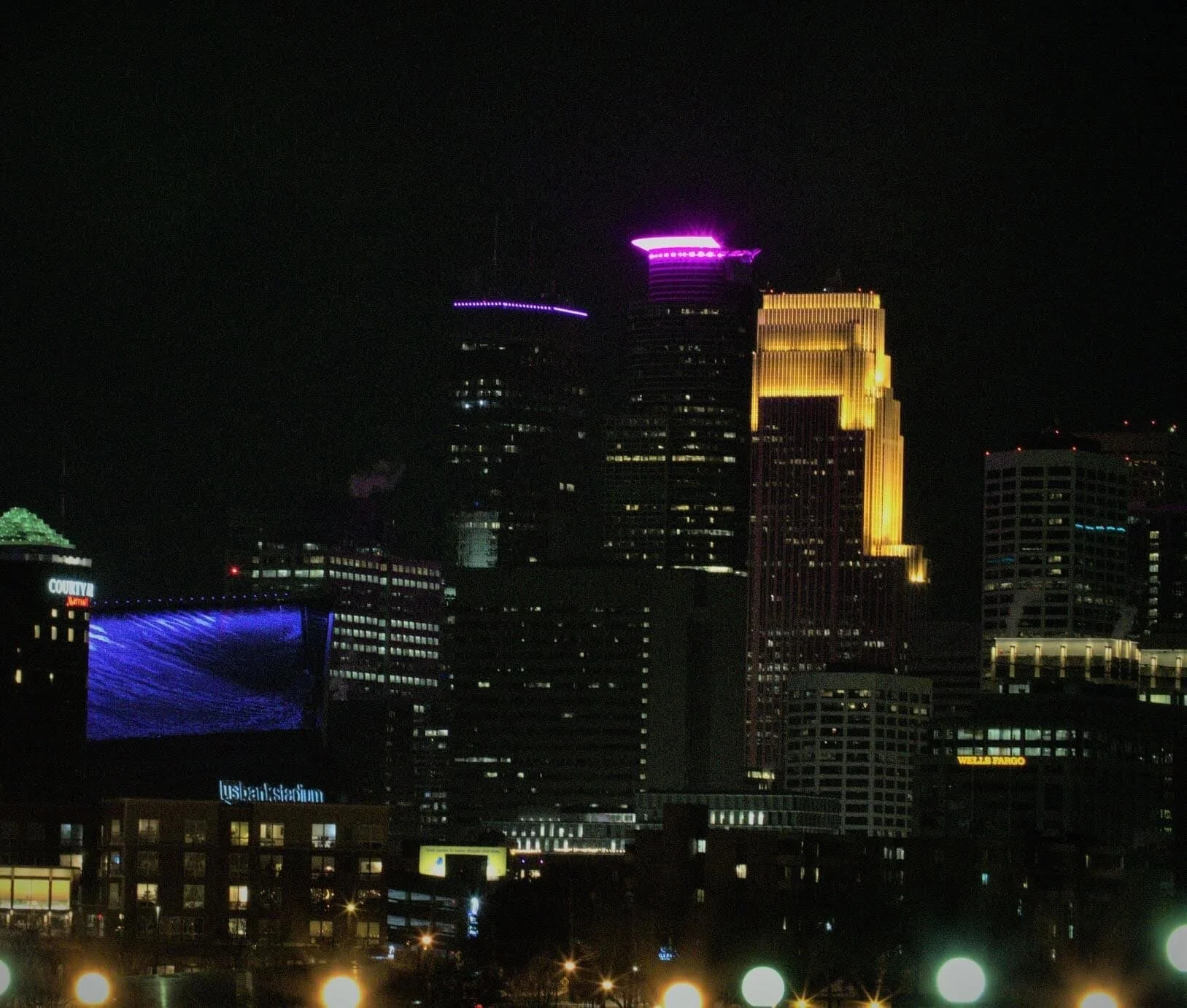 Posted by Kaden S - Took photos from the U of M campus. Buildings in downtown Minneapolis lit up with purple.