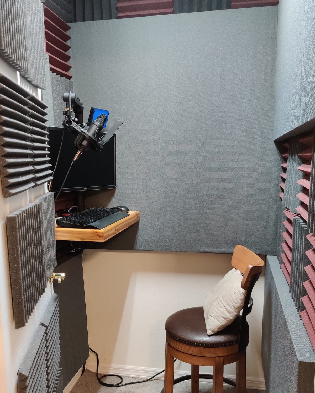 Version 2.0 of the booth features several upgrades including carpet on the ground to further reduce echo at high volume, a larger desk which is far sturdier and built at a height that supports sitting or standing, a monitor connected to the computer