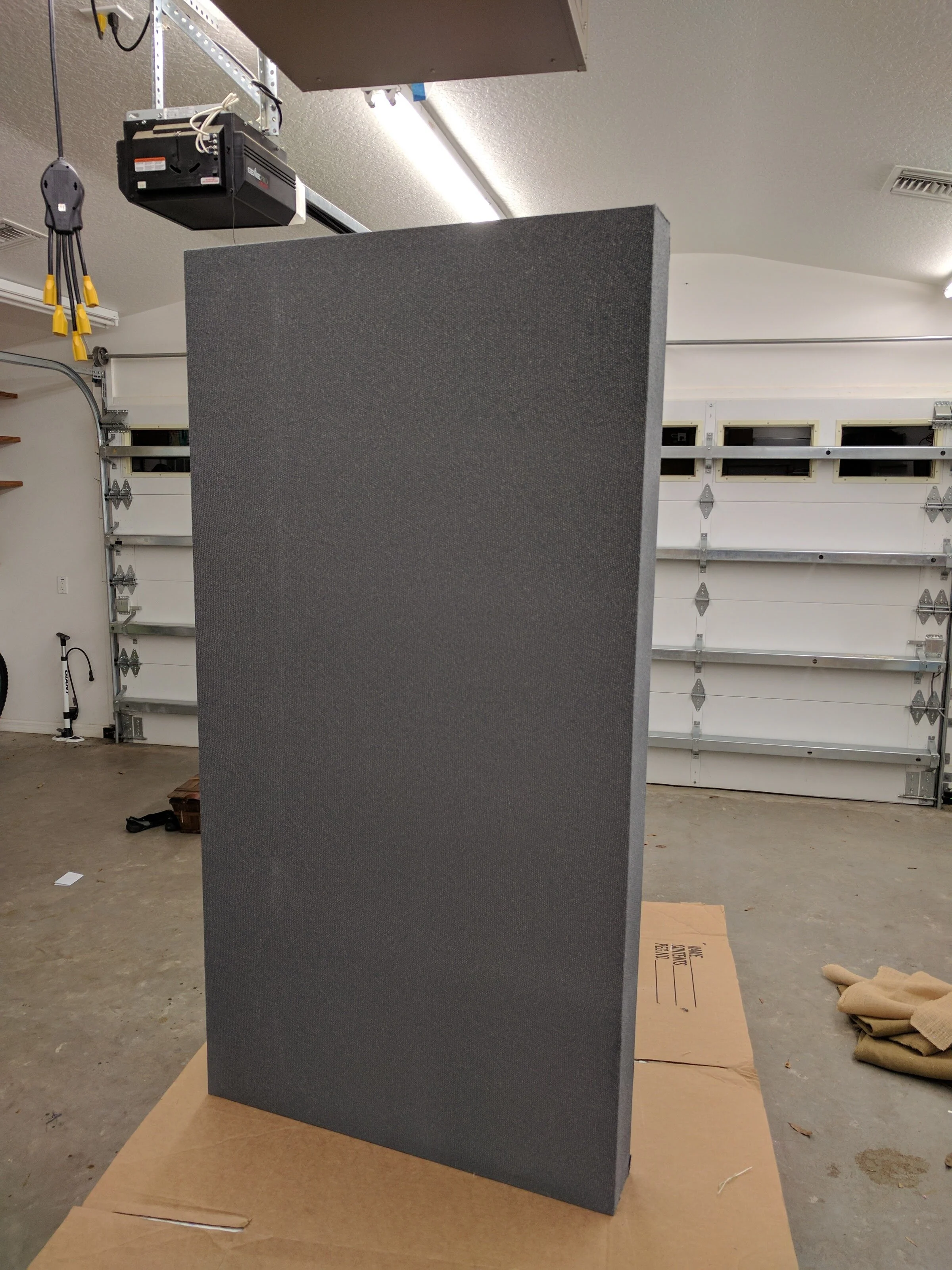 Here is the finished panel after it has been wrapped with fabric and stapled in the back for extra support. What you can't see is the finished back. Because I used fiberglass insulation, it was necessary to fully enclose the back of these panels to p