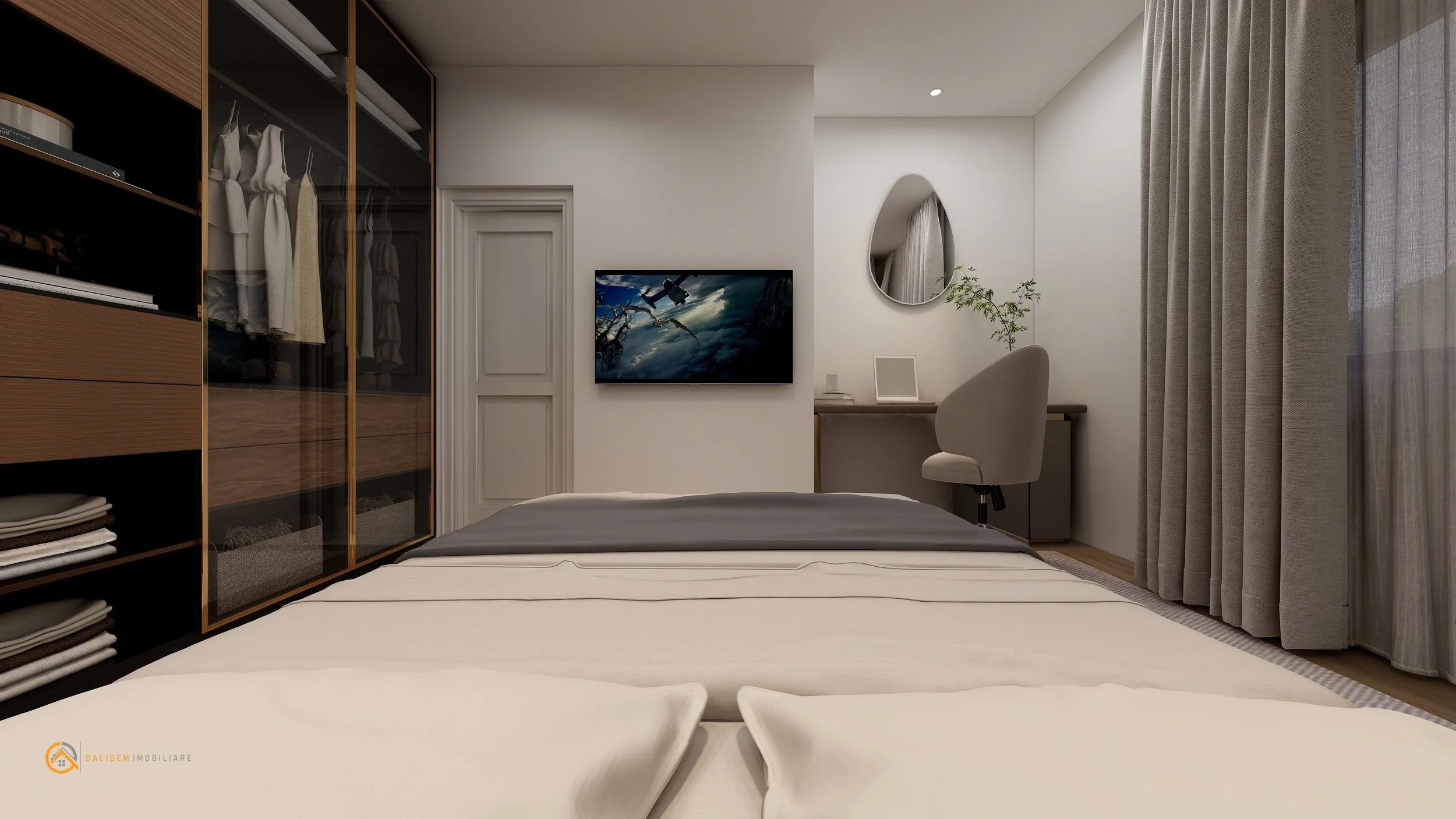 Interior of a modern bedroom showing a bed, a fitted wardrobe with glass doors, a wall-mounted TV, a mirror, a desk with a chair, and large curtains.