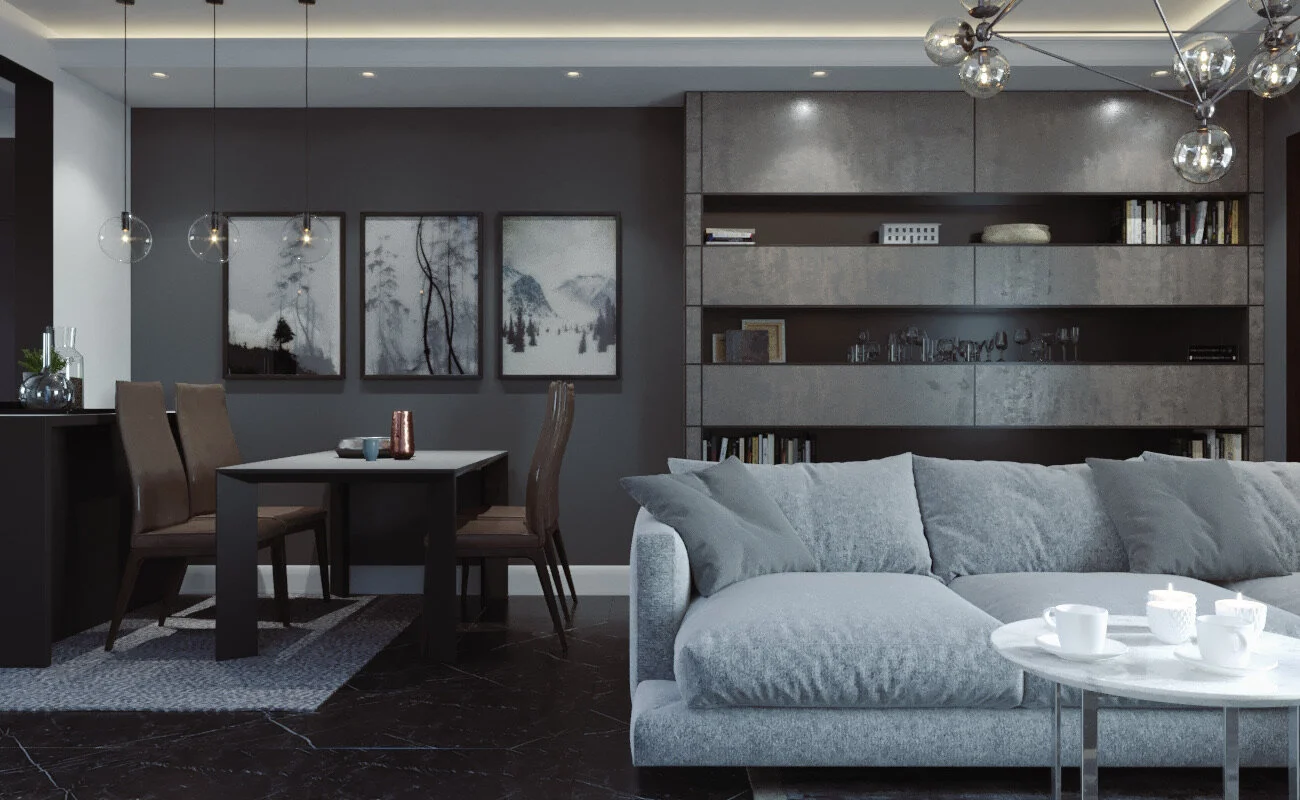 Modern living room with gray sofa, six white cups on a round table, dark wood flooring, a gray accent wall with three framed monochrome landscape pictures, a dining table with four brown chairs, paperweights, framed photos, glassware, books, and cont