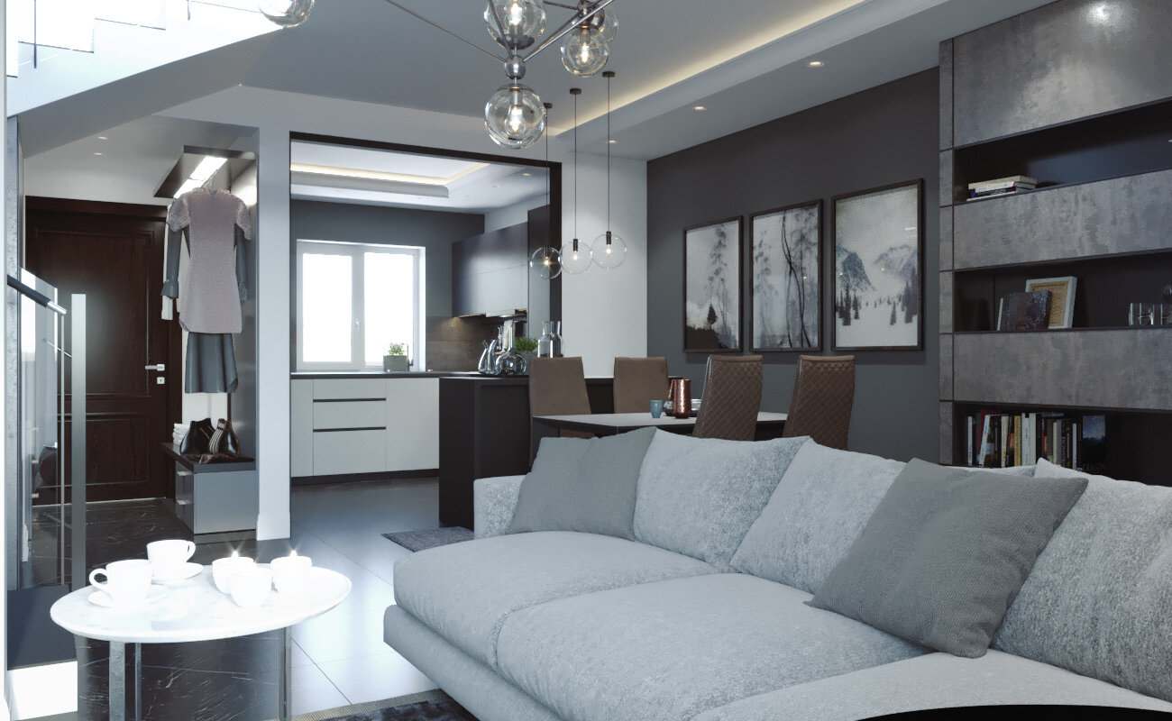 Modern living room with a light gray sofa, coffee cups on a small round table, and a dining area with four chairs and artwork on the wall.