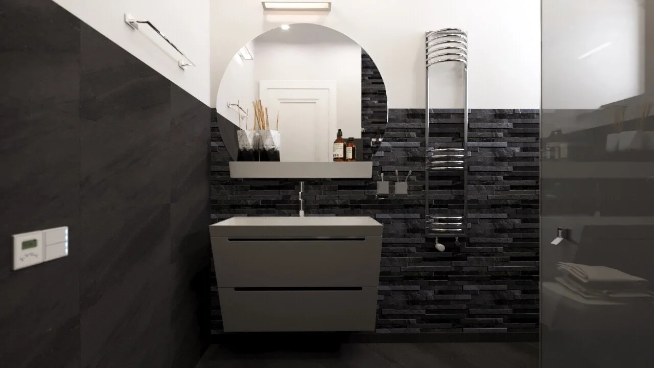 Modern bathroom with black textured wall, white vanity with sink, large circular mirror, and metallic heated towel rack.