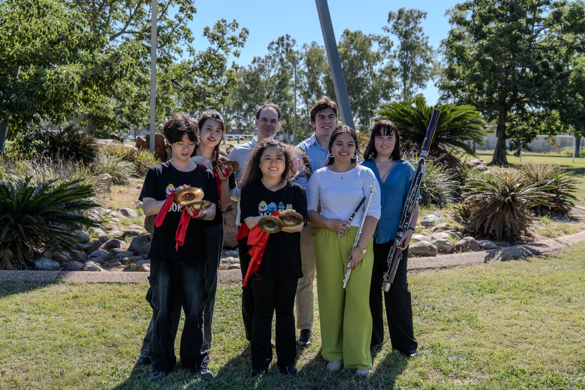 Guest musicans stand together while holding instruments