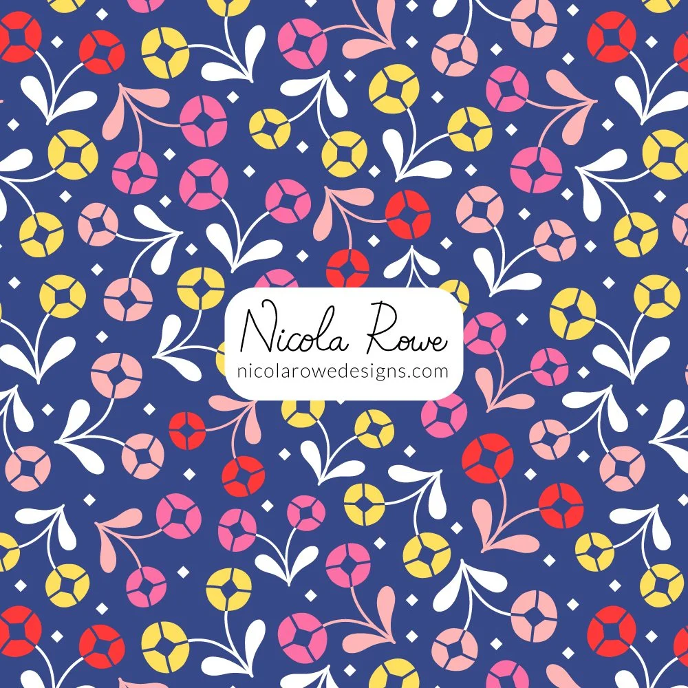 small diamond flowers pattern design with yellow, pink, and red flowers and with white pink leaves on a rich blue background.