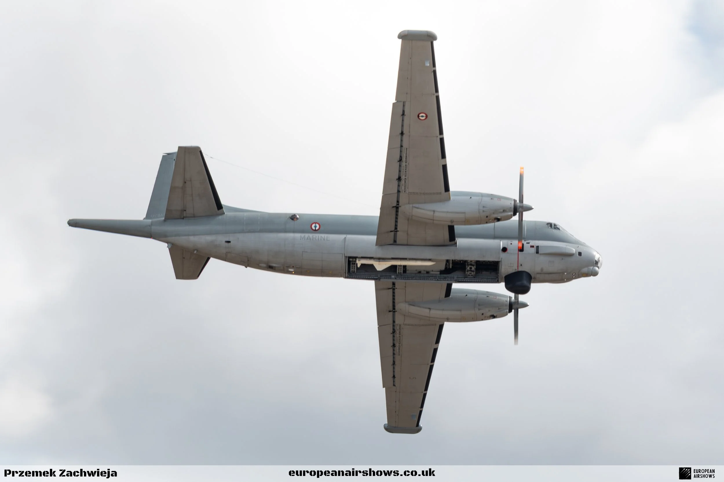 An aircraft flying in the sky with cloudy weather.