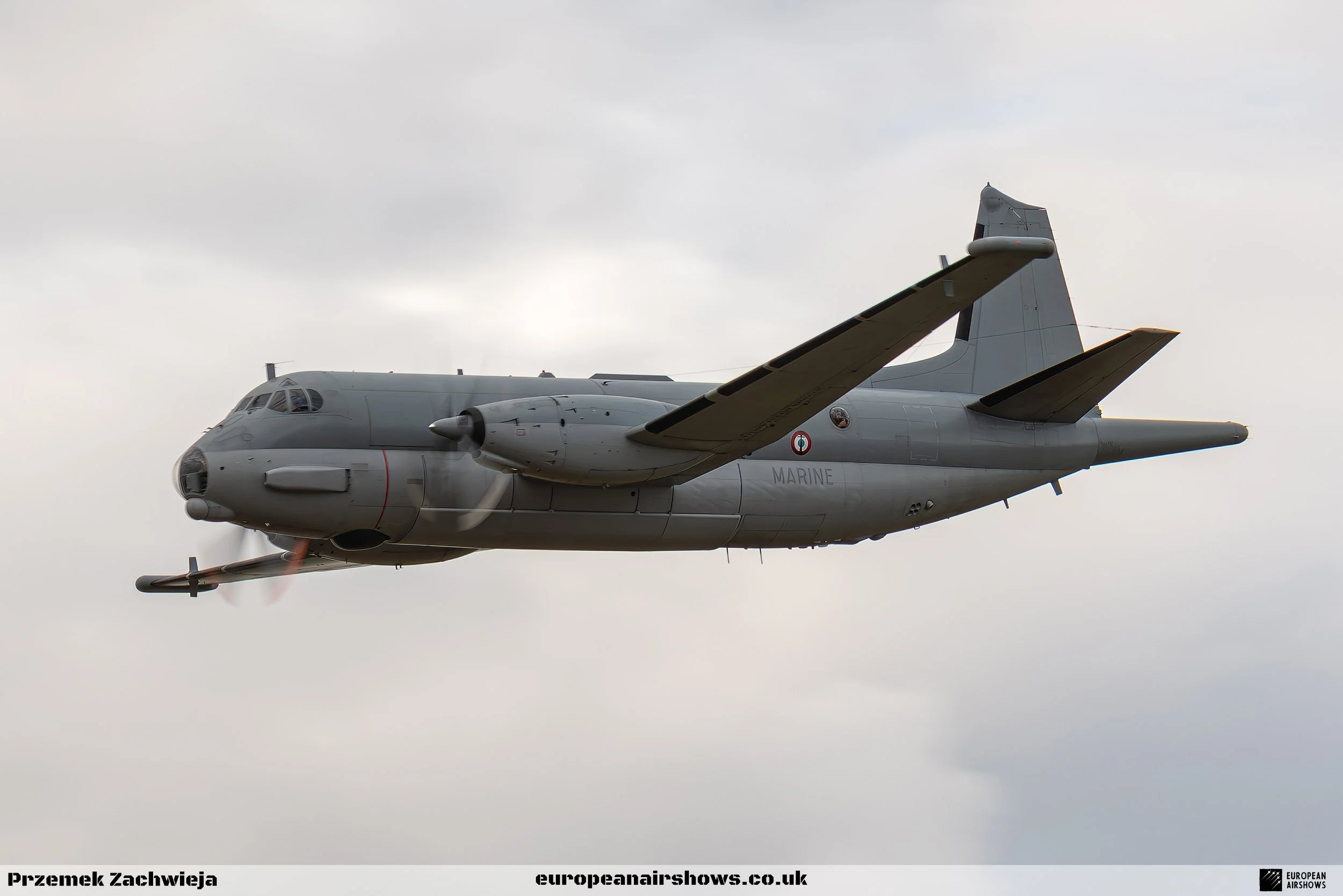 A military aircraft flying in the sky with cloudy weather