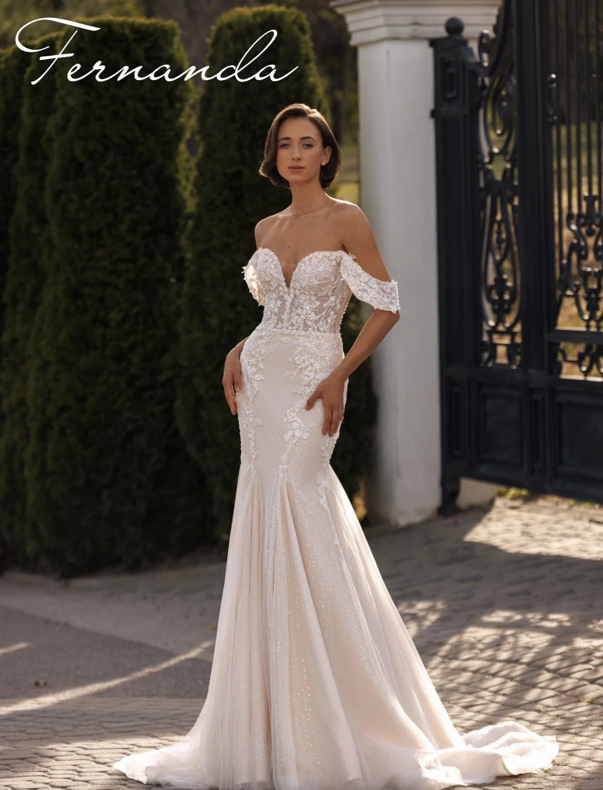 blush sweetheart fishtail wedding dress with draped sleeves, lace appliqué and dramatic train