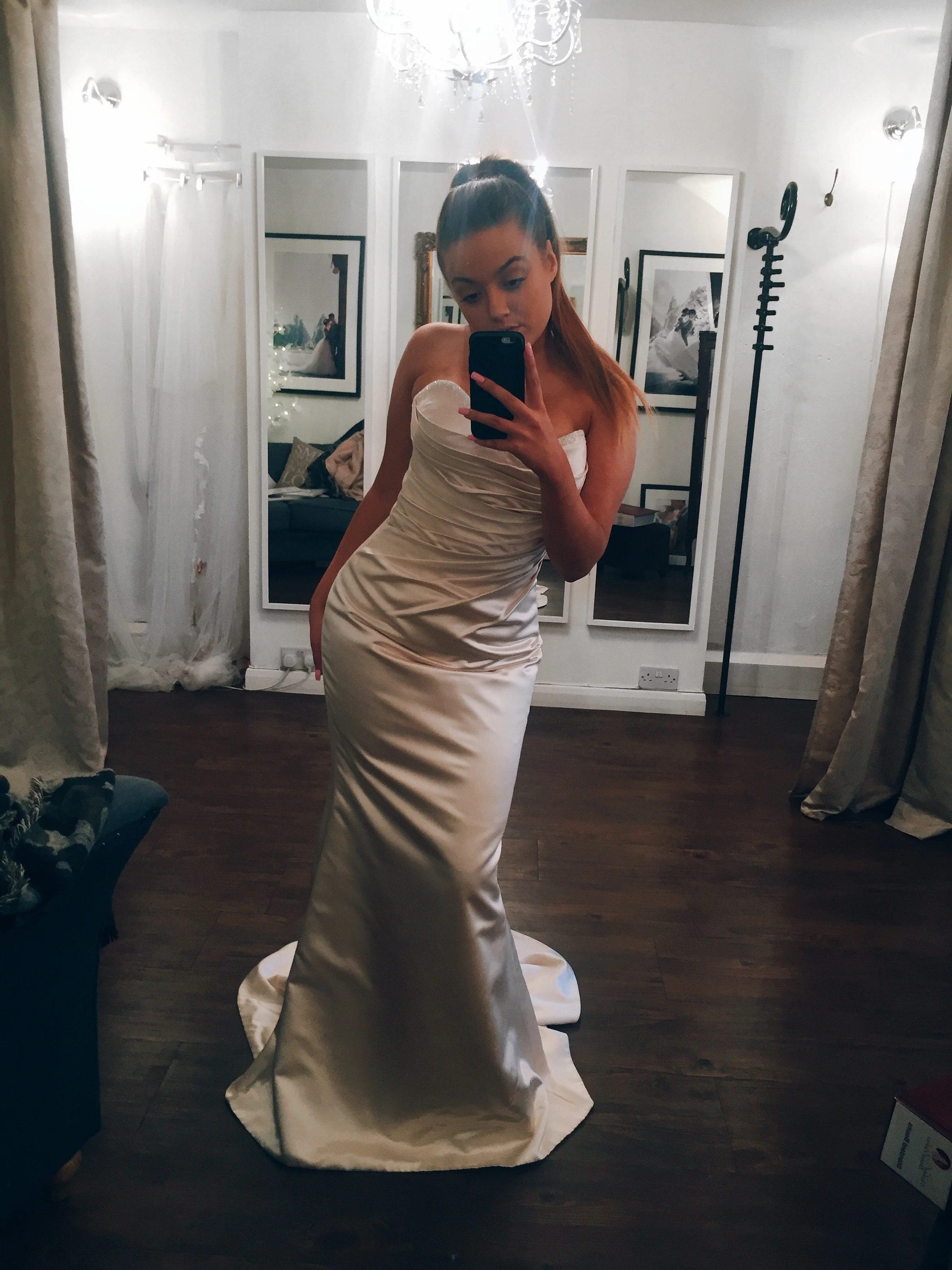 Champagne satin, slim fit bridal gown.  Strapless with a sweetheart neckline, crystal beadwork around the top edge and ruching over the tummy & waistline