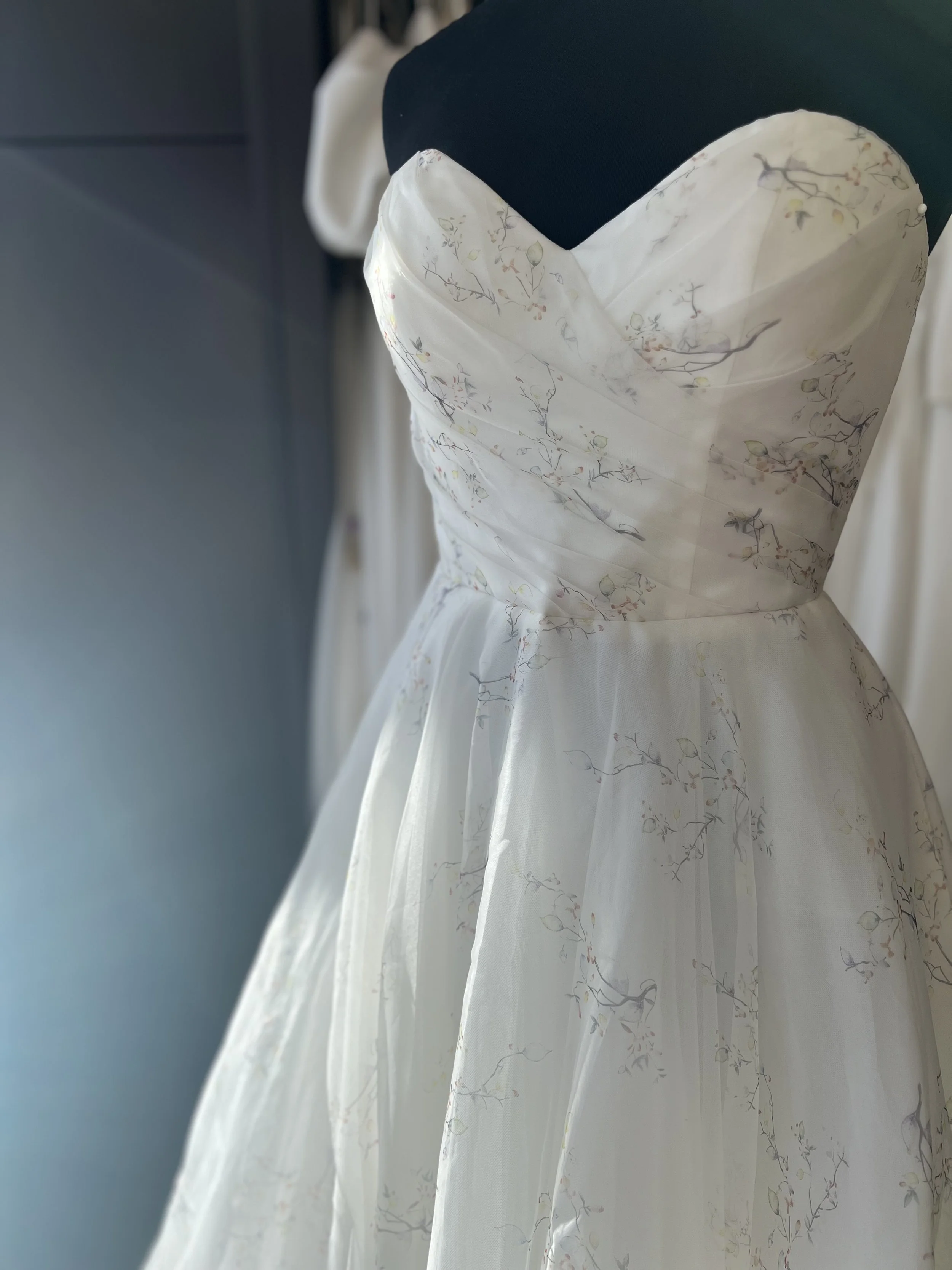 strapless wedding dress with full skirt in printed organza.  Delicate willow print in peach, lemon, green & brown
