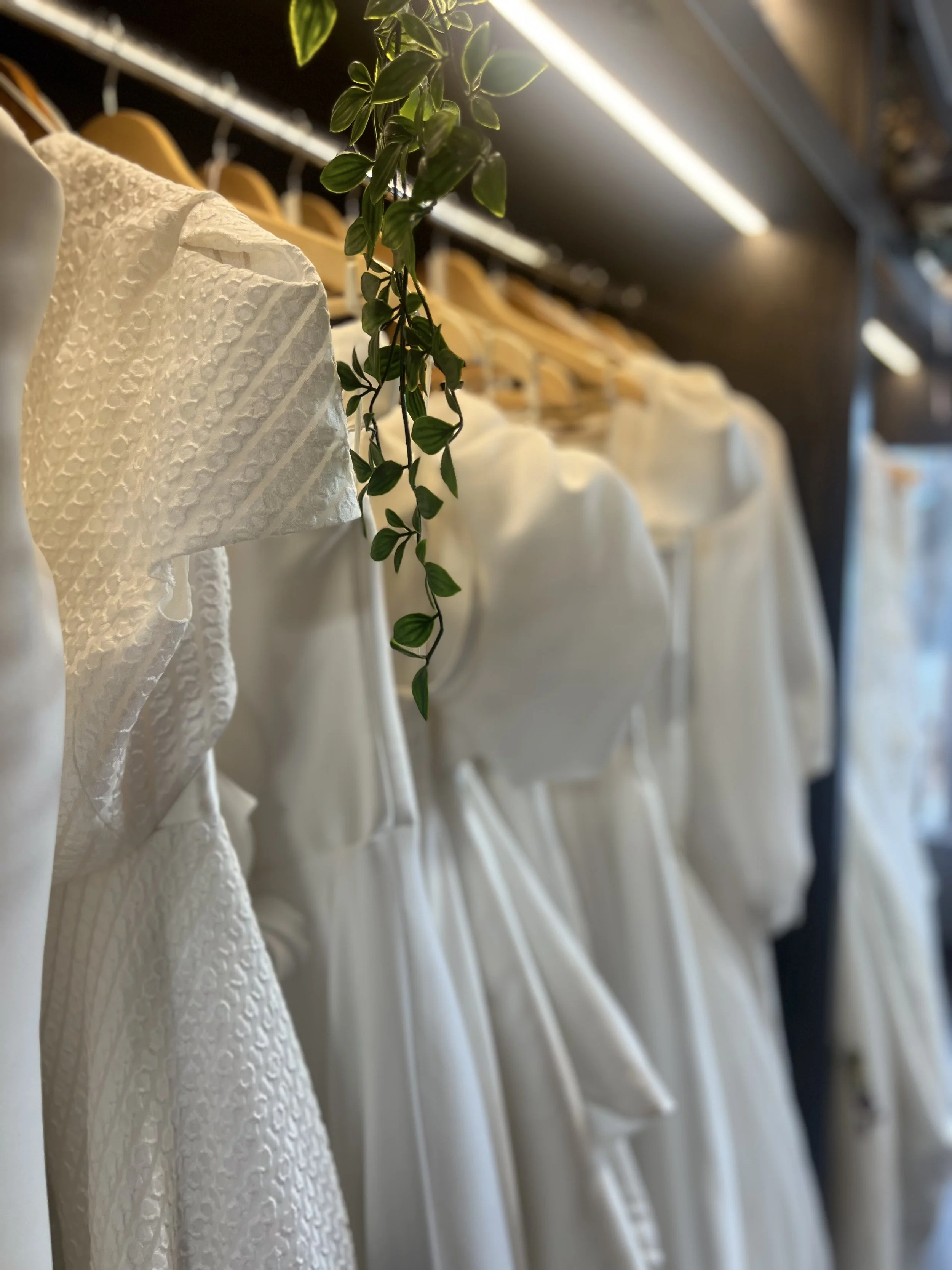 A rail of beautifully spaced couture wedding dresses available at Boo Bridal