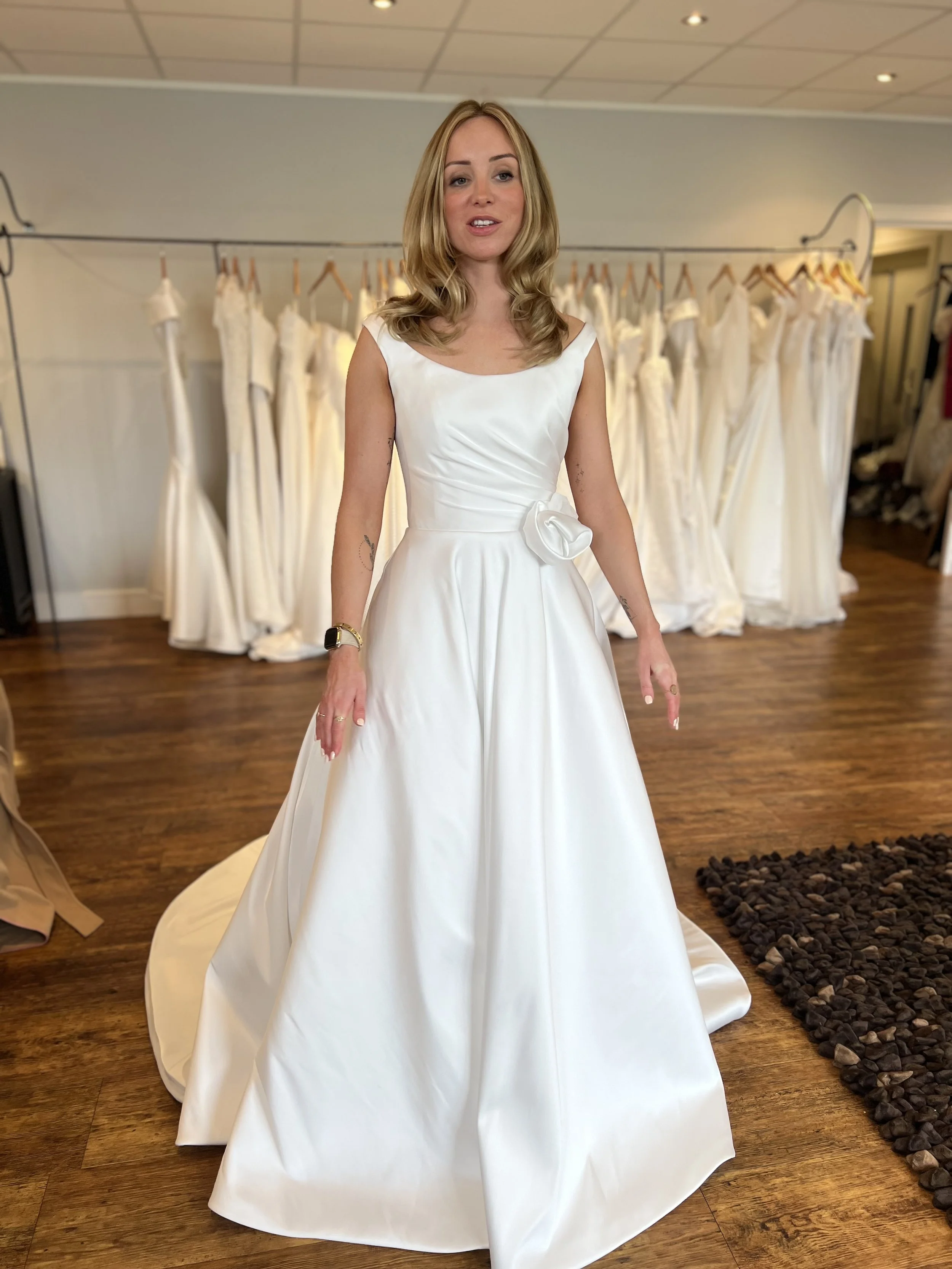 A-line wedding dress, draped portrait neckline, hand made silk flower details at waist