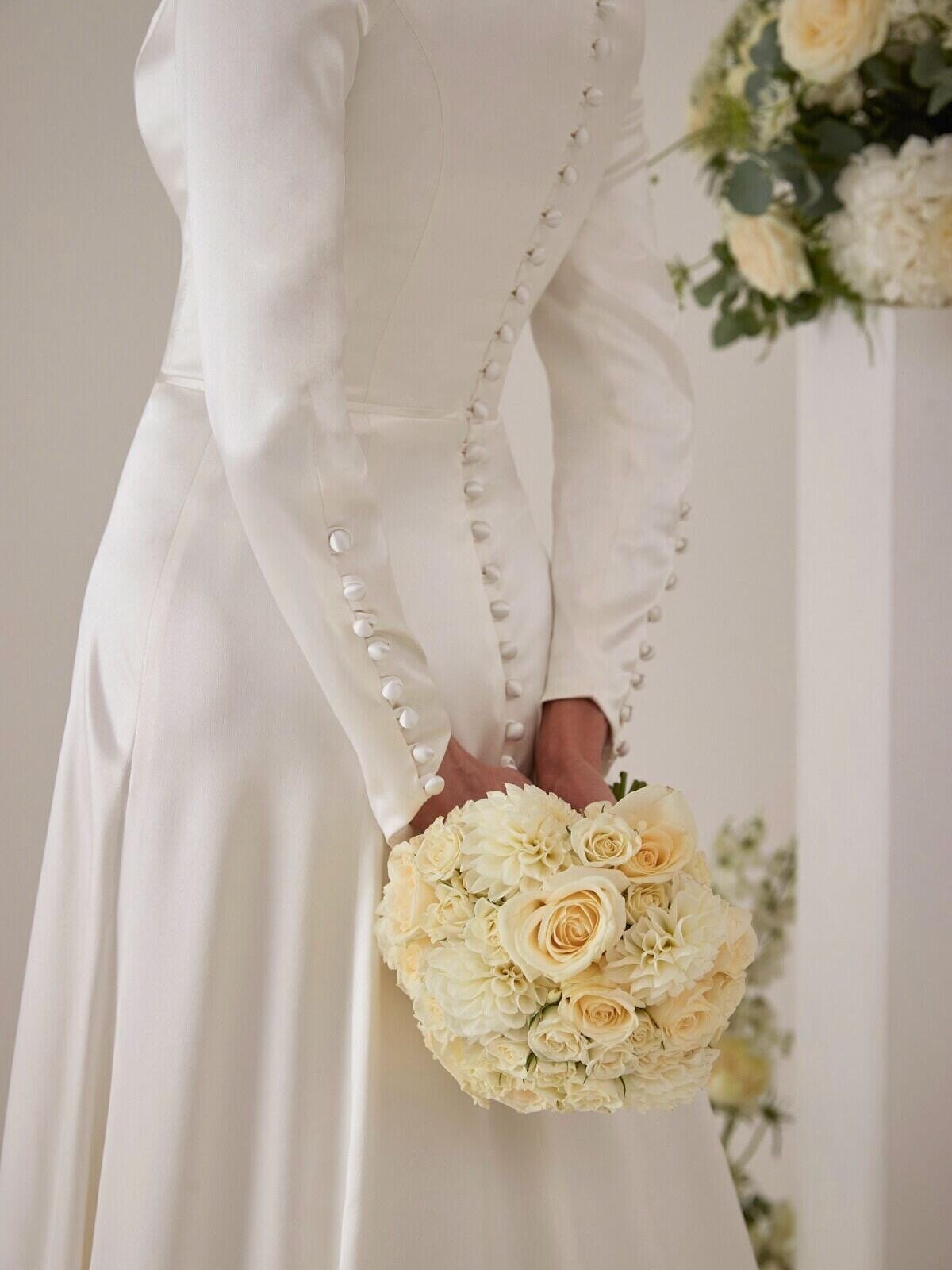 Button details on the sleeves and back fastening of the Amanda bridal gown by Sassi Holford available at Boo Bridal Hampshire