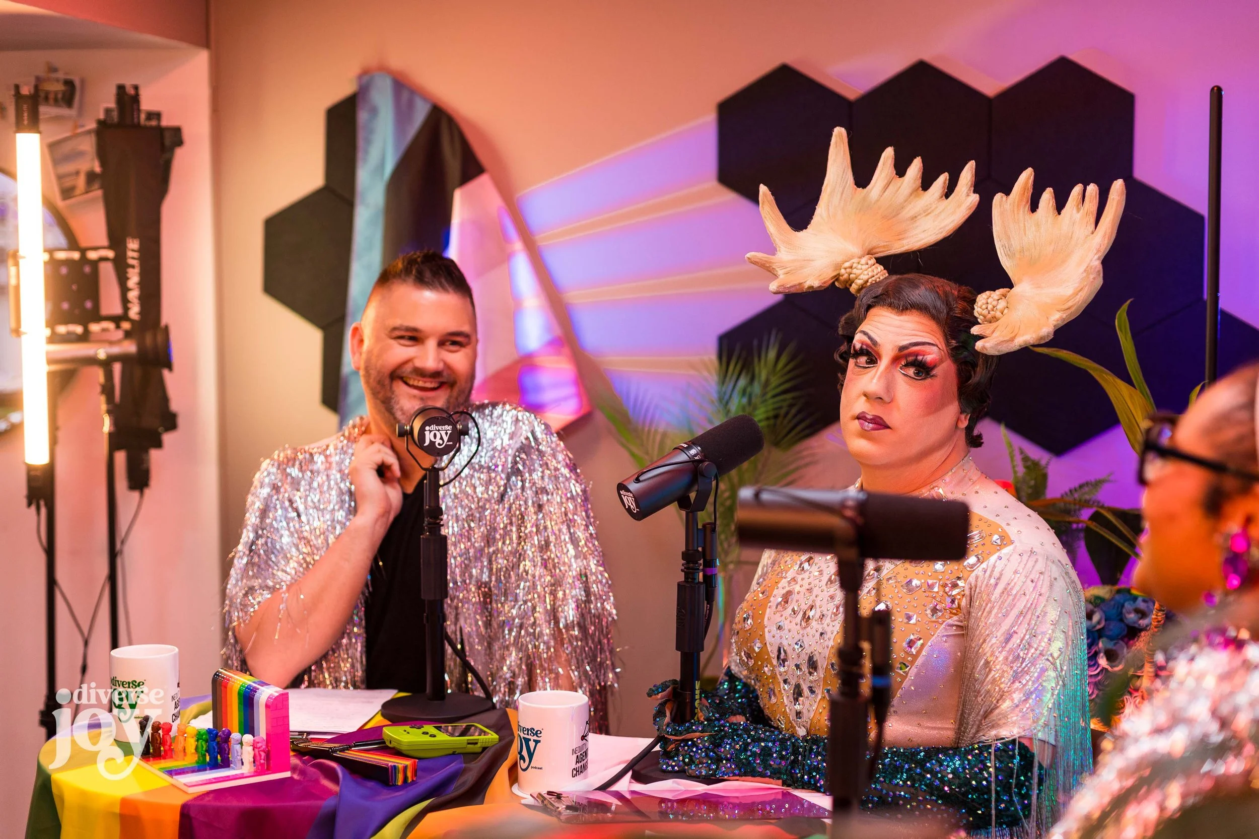 Dr. William T. L. Cox and drag legend Cynthia Mooseknuckle look on while Dr. Amber Nelson talks during a recording session of Diverse Joy Podcast