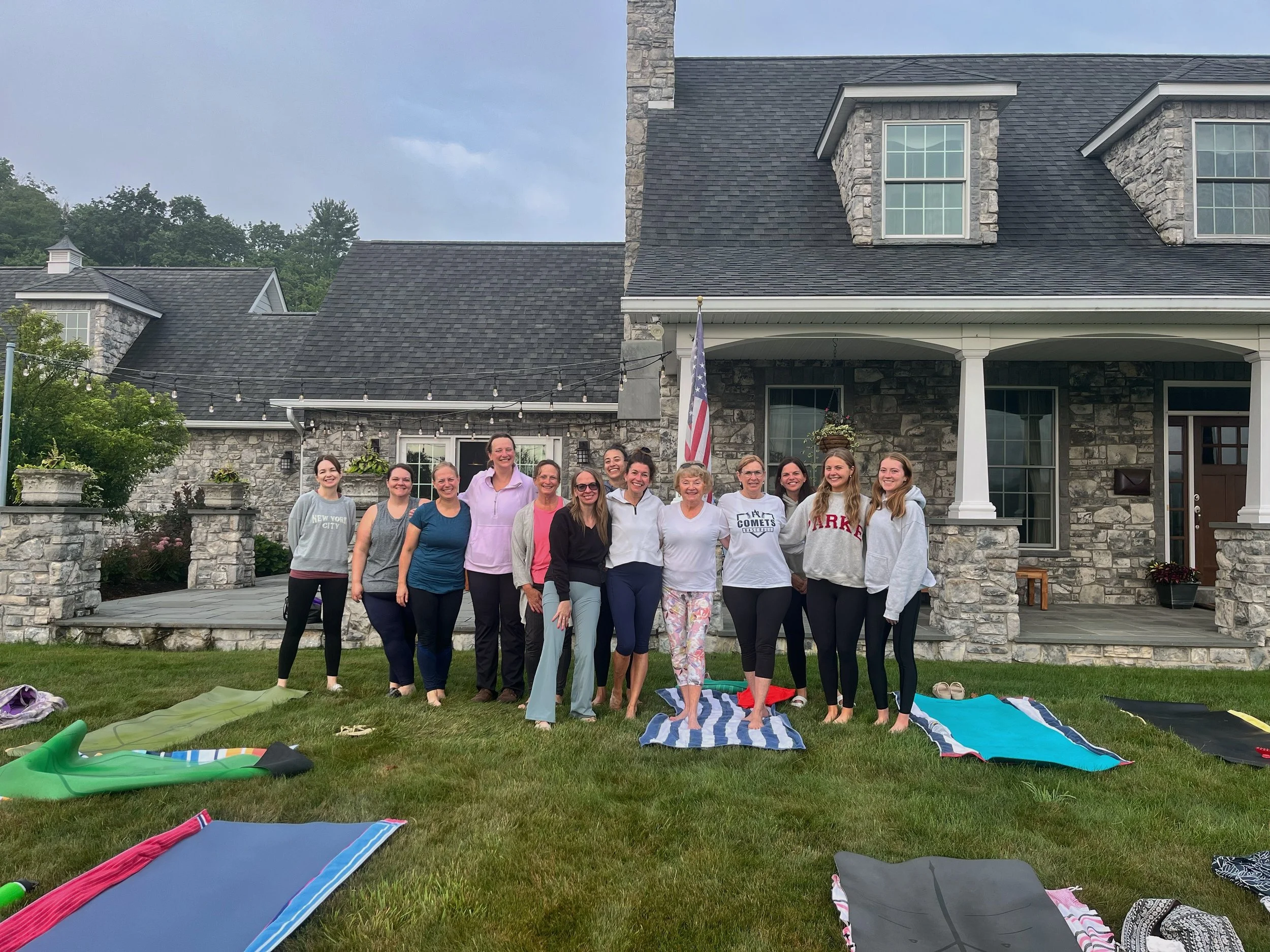 The Jaya Yoga Studio Sunrise Crew gathers together after a morning of outdoor yoga, breakfast, and community.